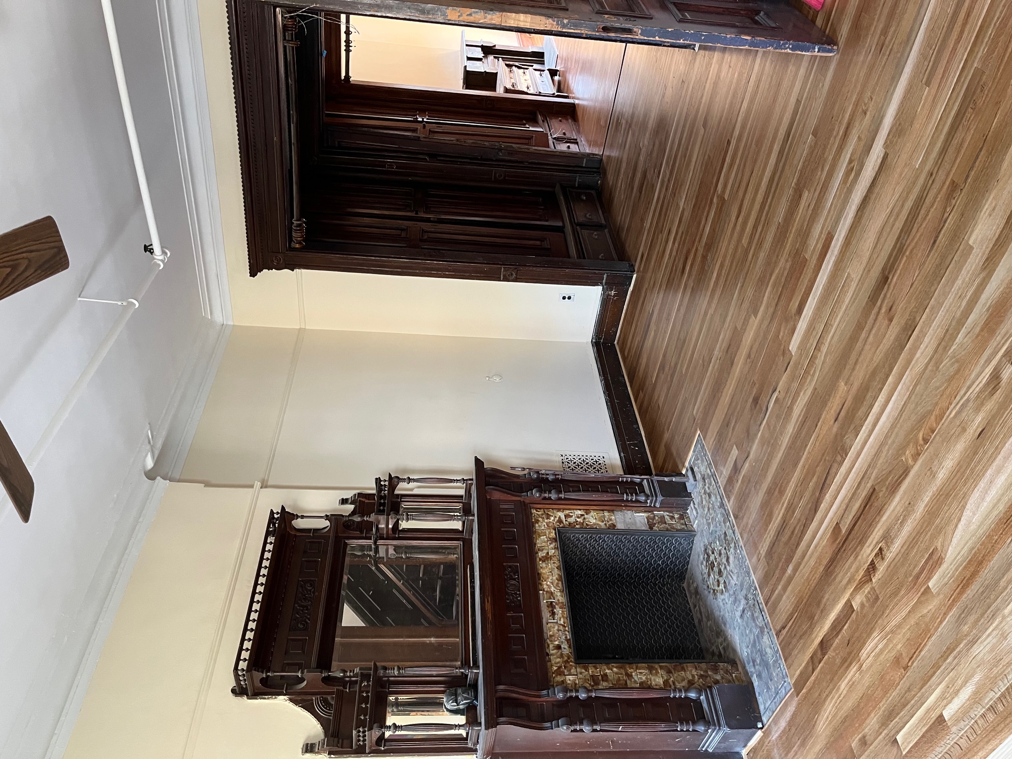 106 West 131st Street Manhattan, NY 10027 - Photo 9 of 16 a view of a livingroom with wooden floor and a fireplace