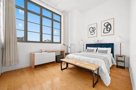 a bedroom with a bed and a couch