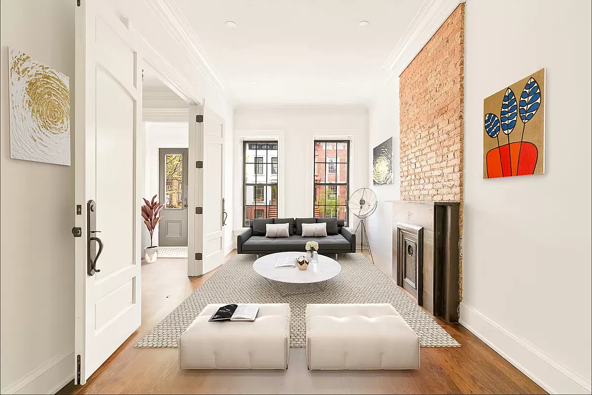 a view of a dining room with furniture and a chandelier