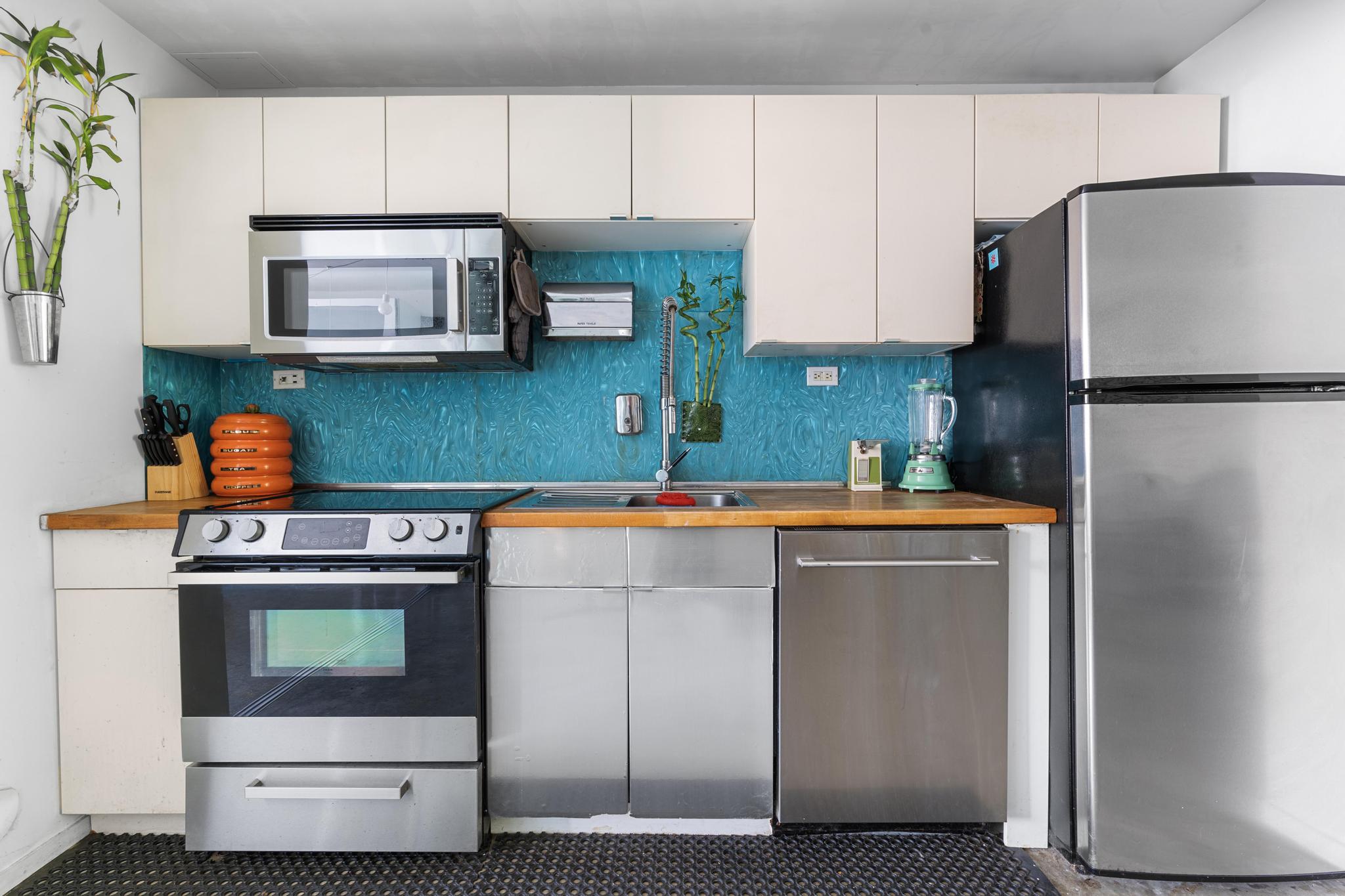 1311 Pacific Street, Unit 405 Brooklyn, NY 11216 - Photo 6 of 9 a kitchen with stainless steel appliances white cabinets and a refrigerator