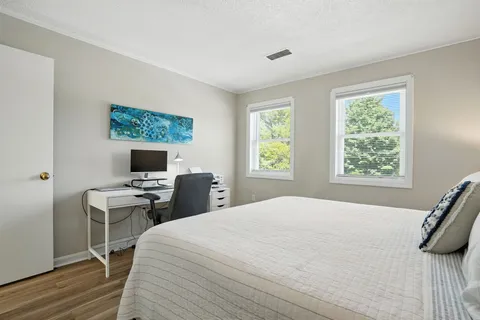 a bedroom with a bed and a desk