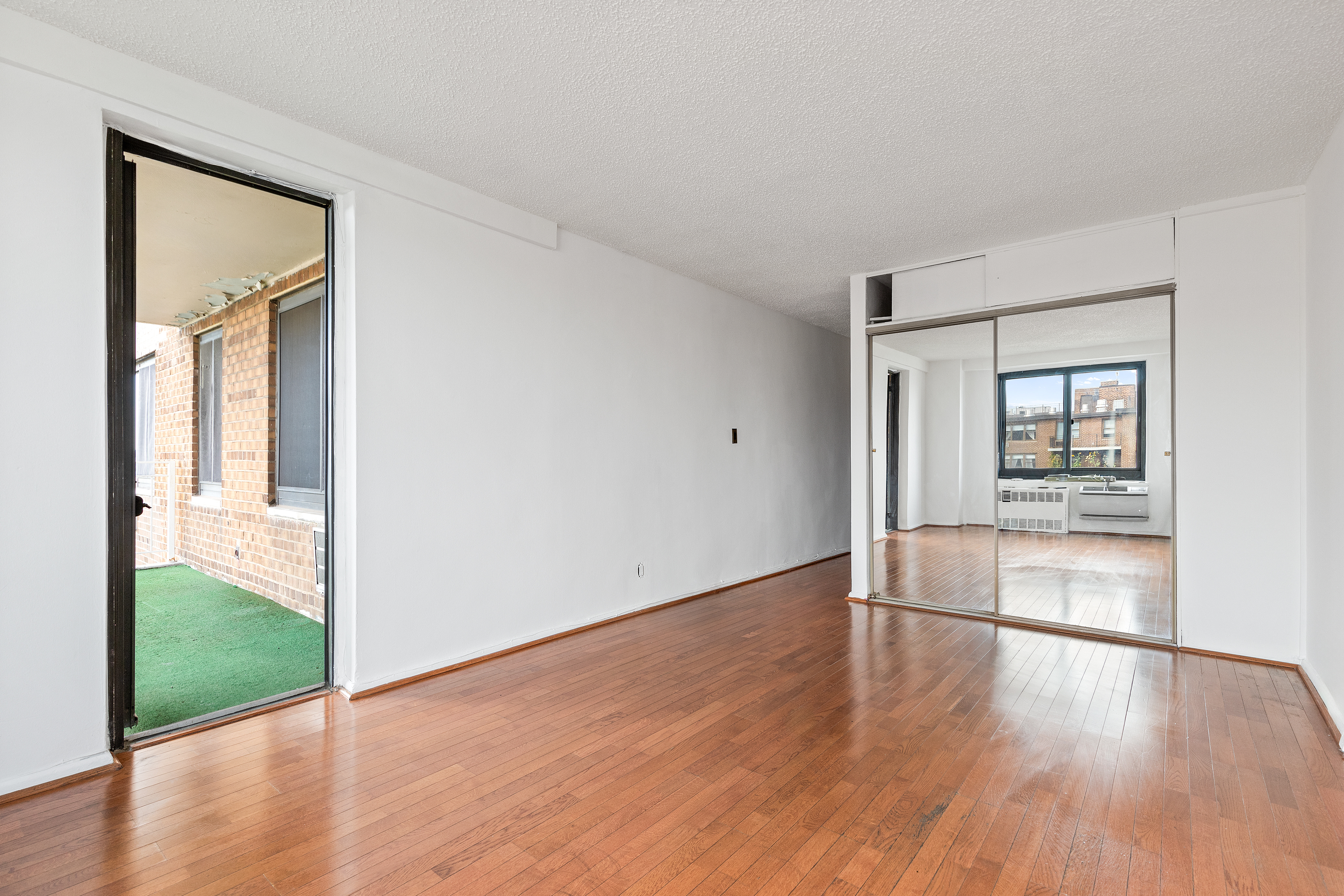 195 Willoughby Avenue, Unit 1612 Brooklyn, NY 11205 - Photo 7 of 10 wooden floor in an empty room with a window