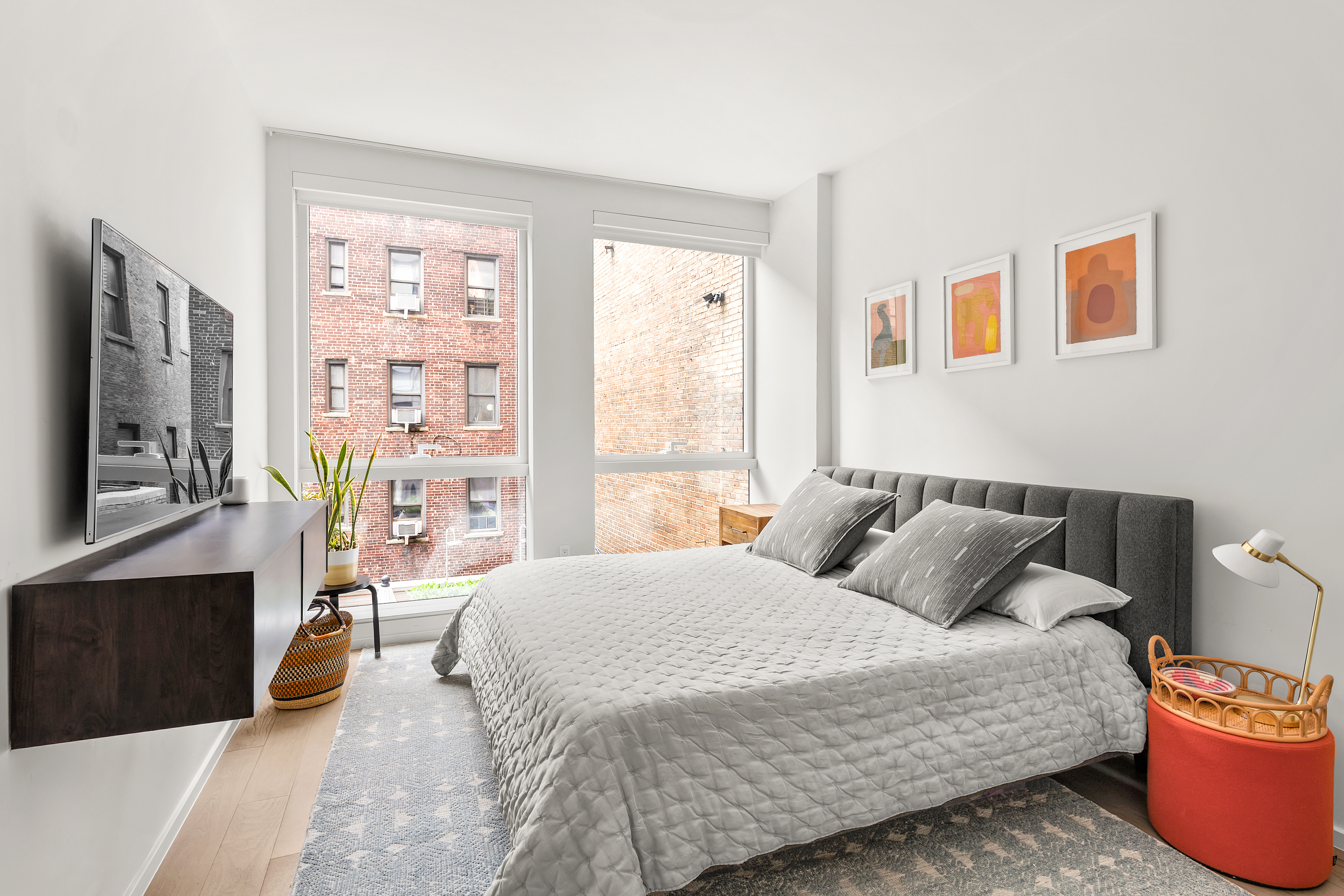 150 East 23rd Street, Unit 3C Manhattan, NY 10010 - Photo 4 of 12 a bedroom with a bed and a table in it