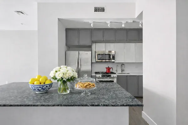a kitchen with a sink a stove and cabinets