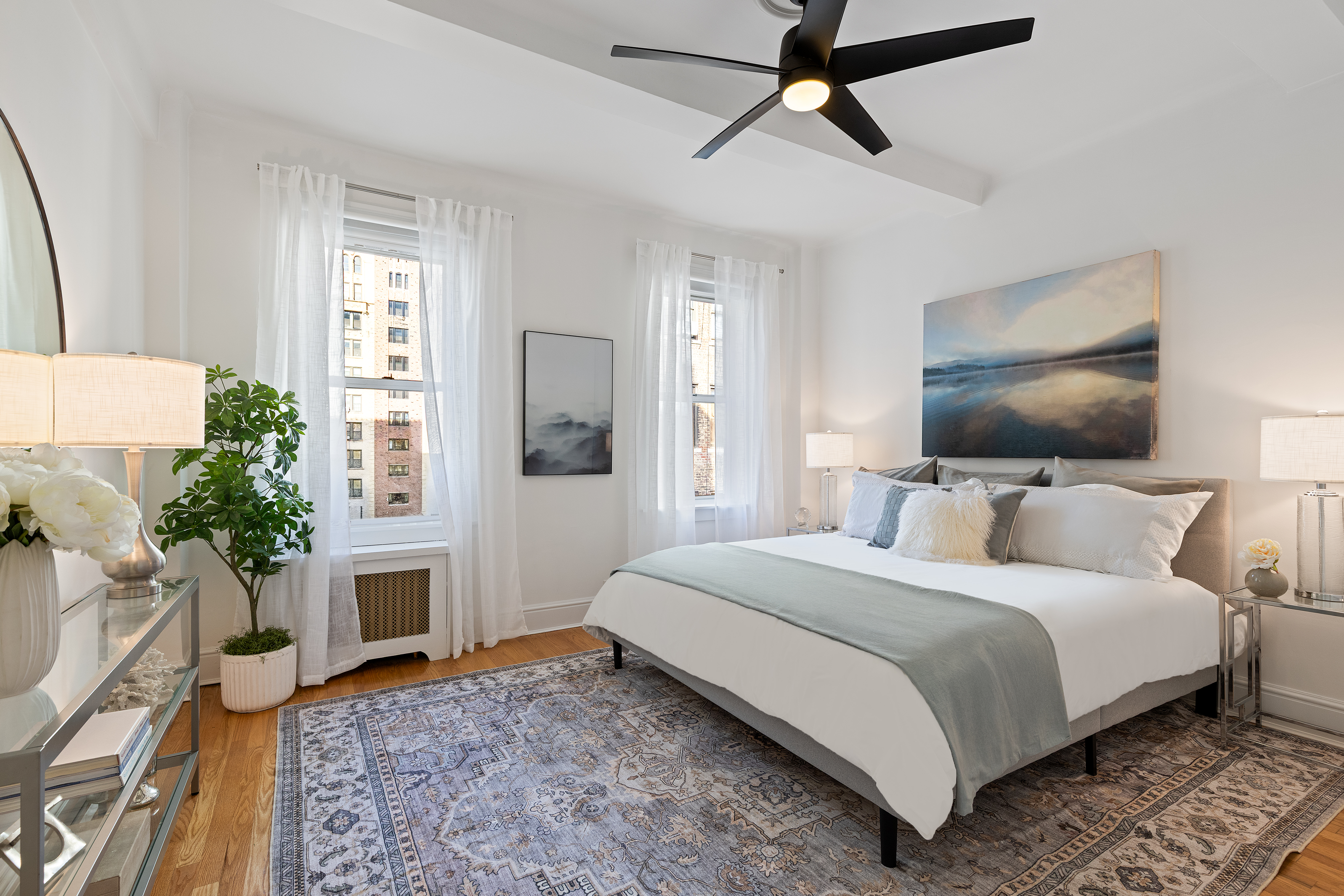 59 West 71st Street, Unit 9C Manhattan, NY 10023 - Photo 5 of 11 a bedroom with a bed and a chandelier