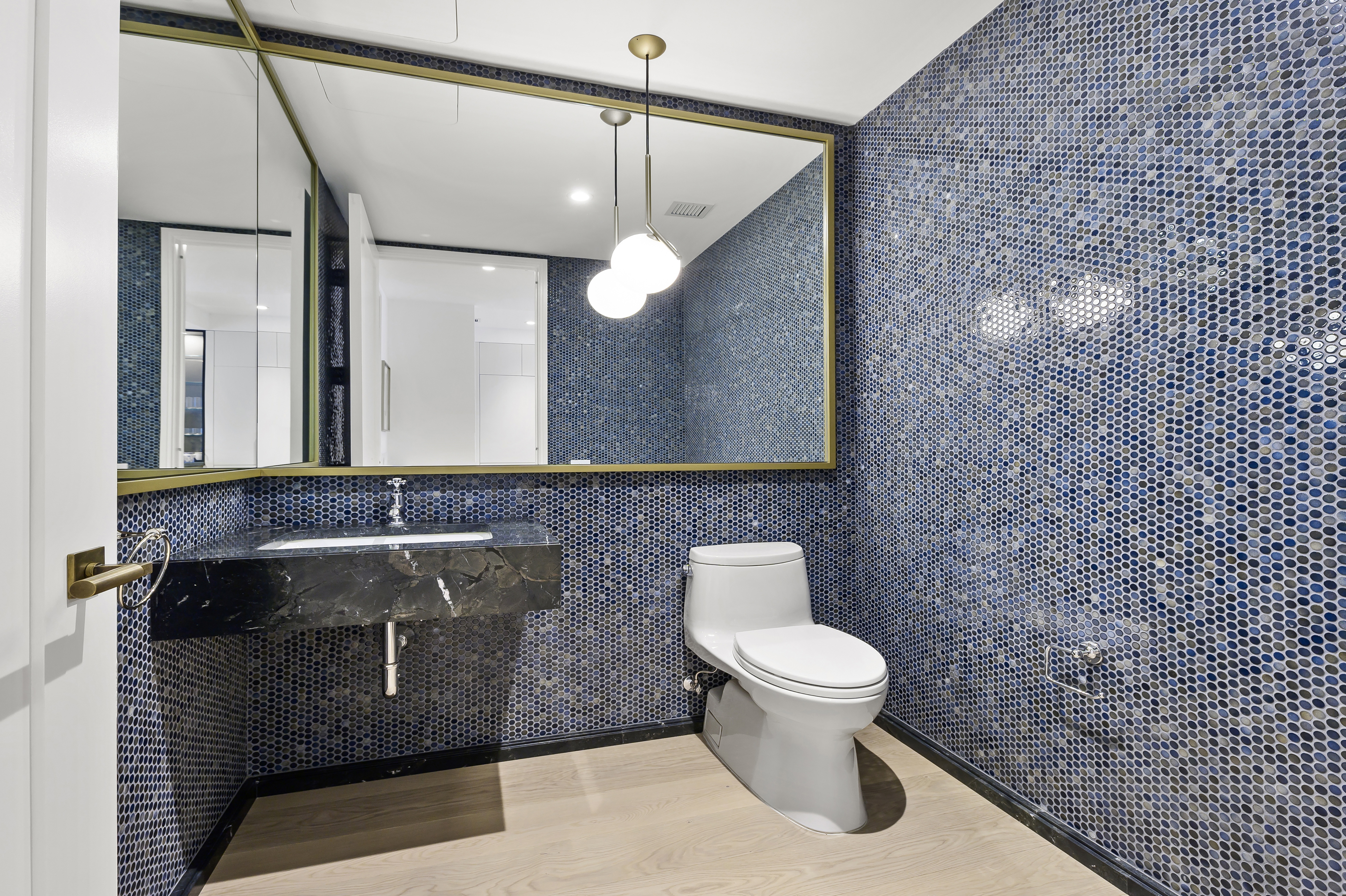 438 East 12th Street, Unit 5B Manhattan, NY 10009 - Photo 6 of 9 a bathroom with a sink a toilet and a mirror