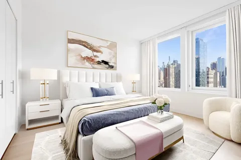 a bedroom with two beds and a large window