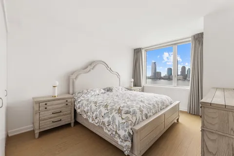 a bedroom with a bed and large mirror