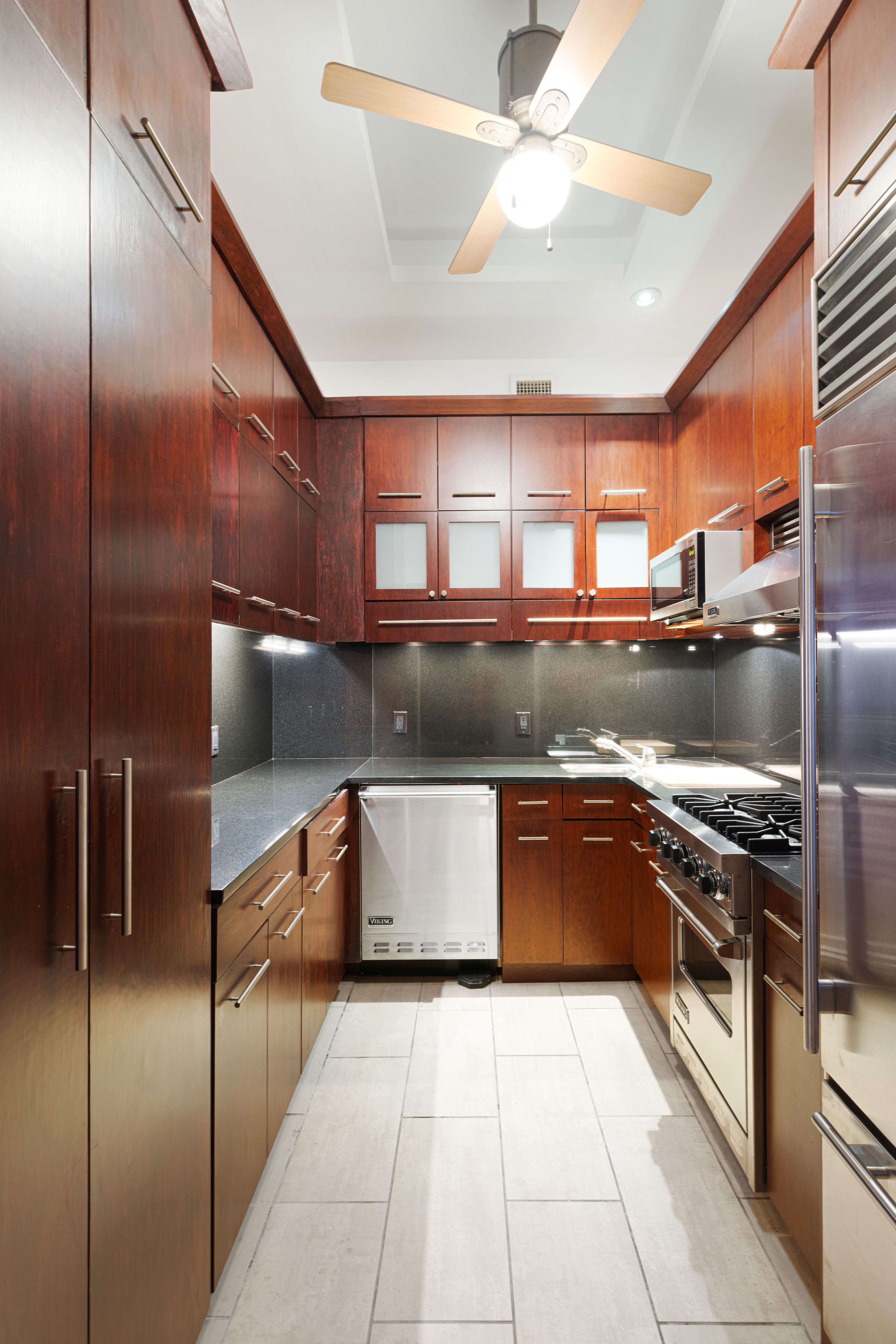 250 Mercer Street, Unit B203 Manhattan, NY 10012 - Photo 6 of 19 a kitchen with stainless steel appliances granite countertop a sink and a stove