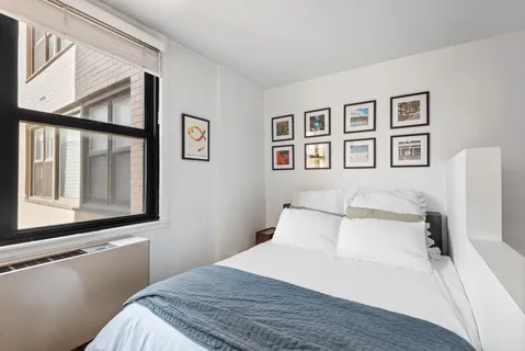 a bedroom with a bed and a window