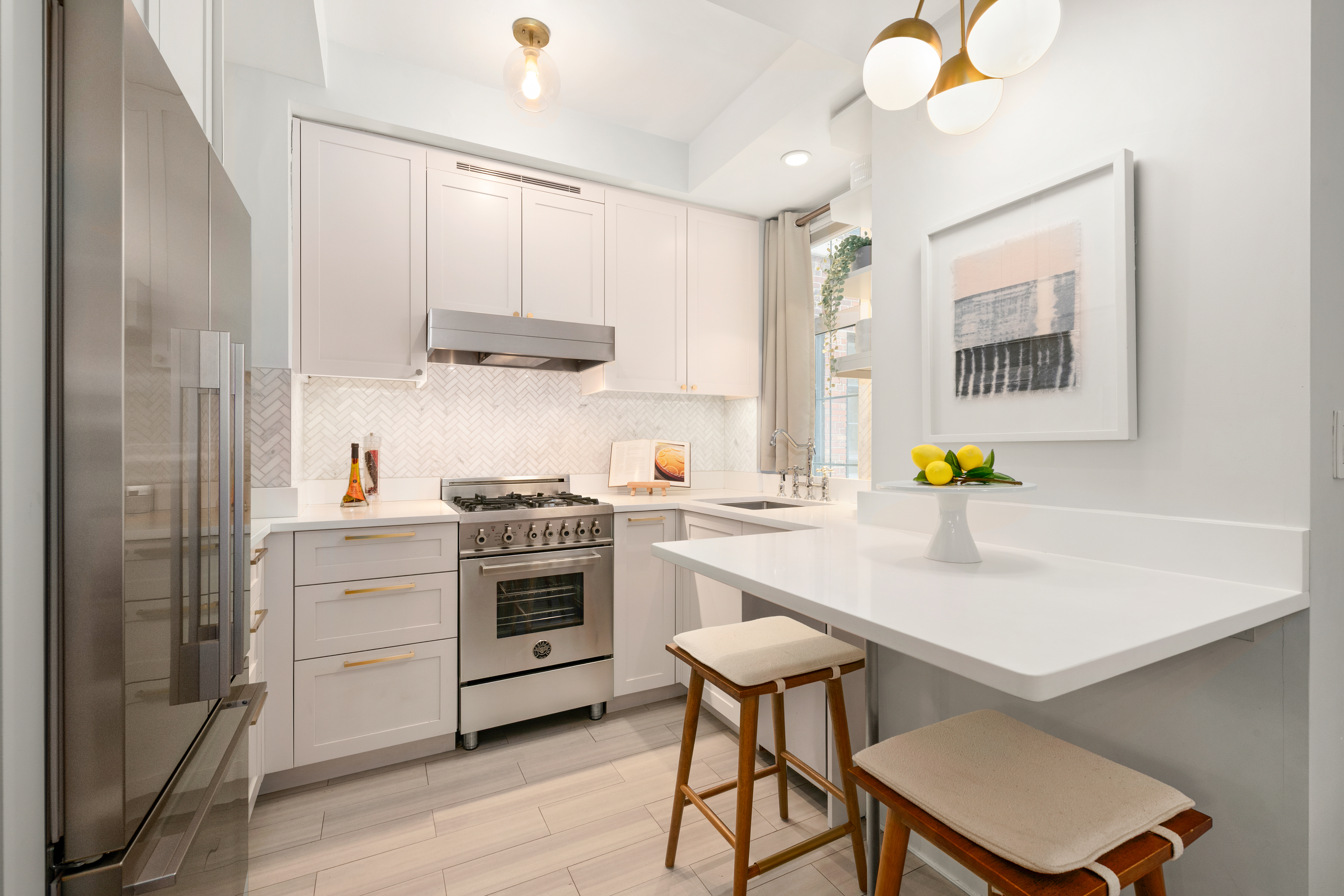 465 West 23rd Street, Unit 2G Manhattan, NY 10011 - Photo 5 of 11 a kitchen with a sink cabinets and stainless steel appliances