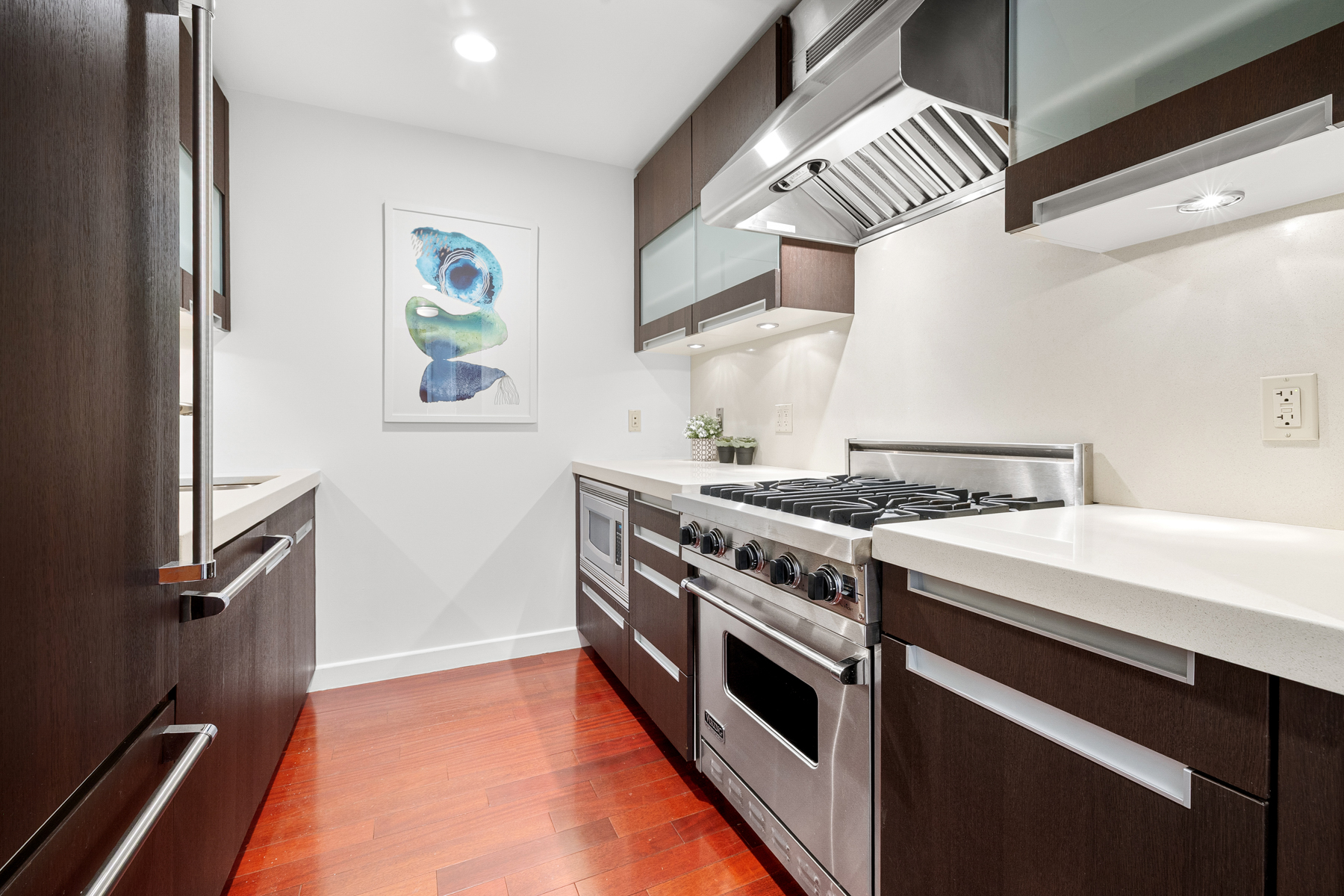 125 West 21st Street, Unit 4C Manhattan, NY 10011 - Photo 7 of 12 a kitchen with stainless steel appliances a stove and a refrigerator