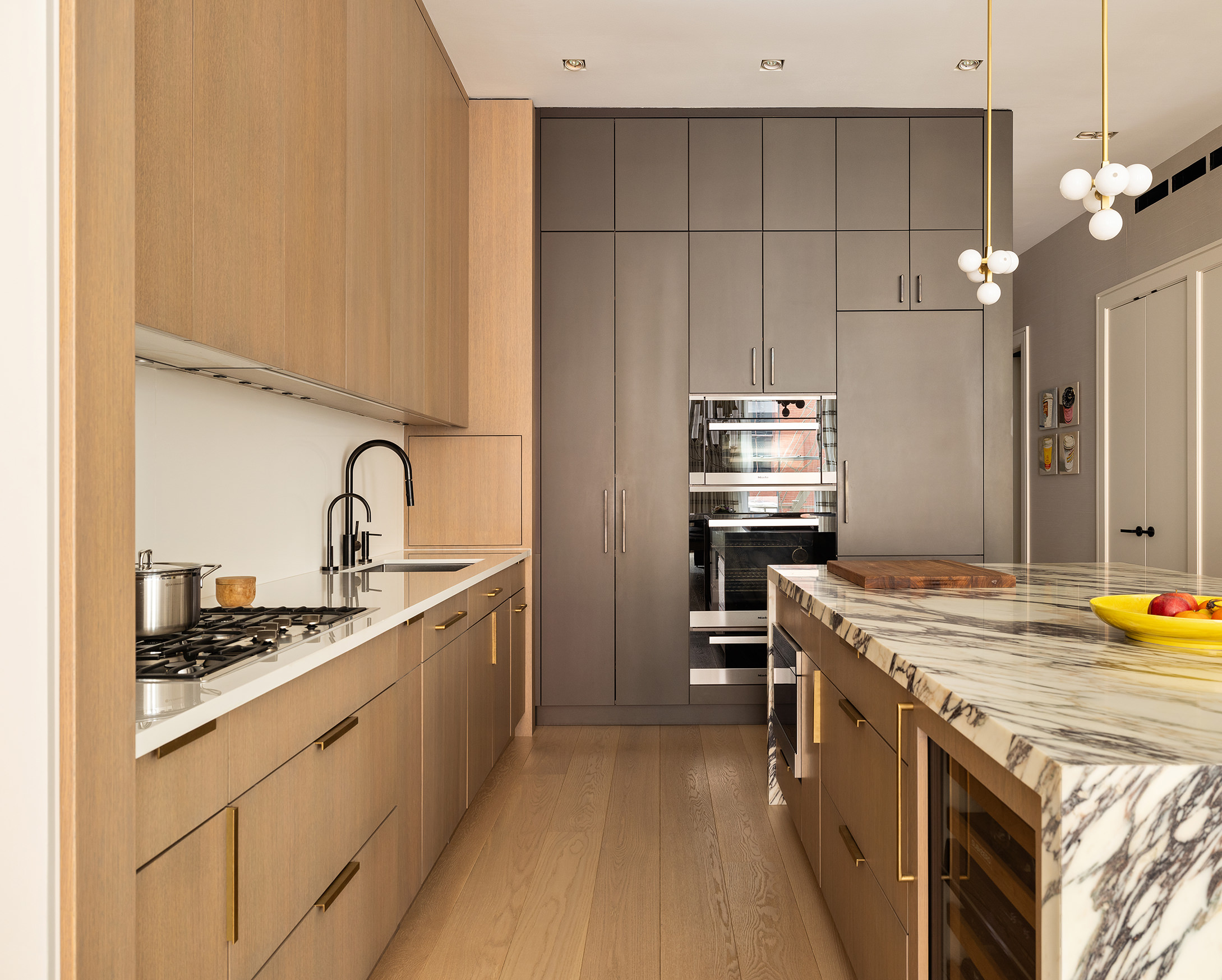 53 Greene Street, Unit 3 Manhattan, NY 10013 - Photo 8 of 22 a kitchen that has a sink and a stove