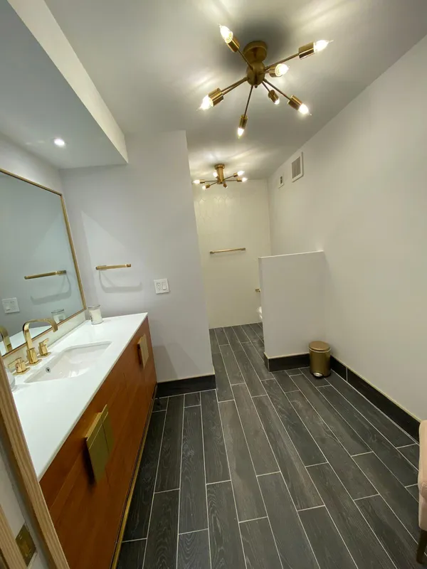 a bathroom with a toilet a sink and a mirror