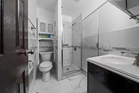 a bathroom with a sink toilet and shower