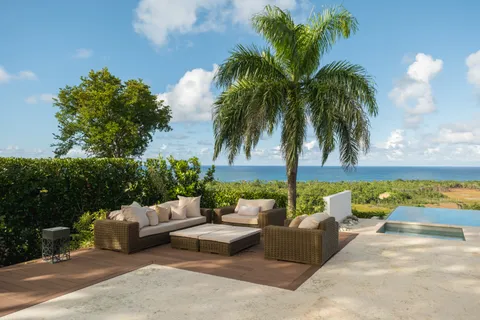 a bedroom with a bed a mirror and couch