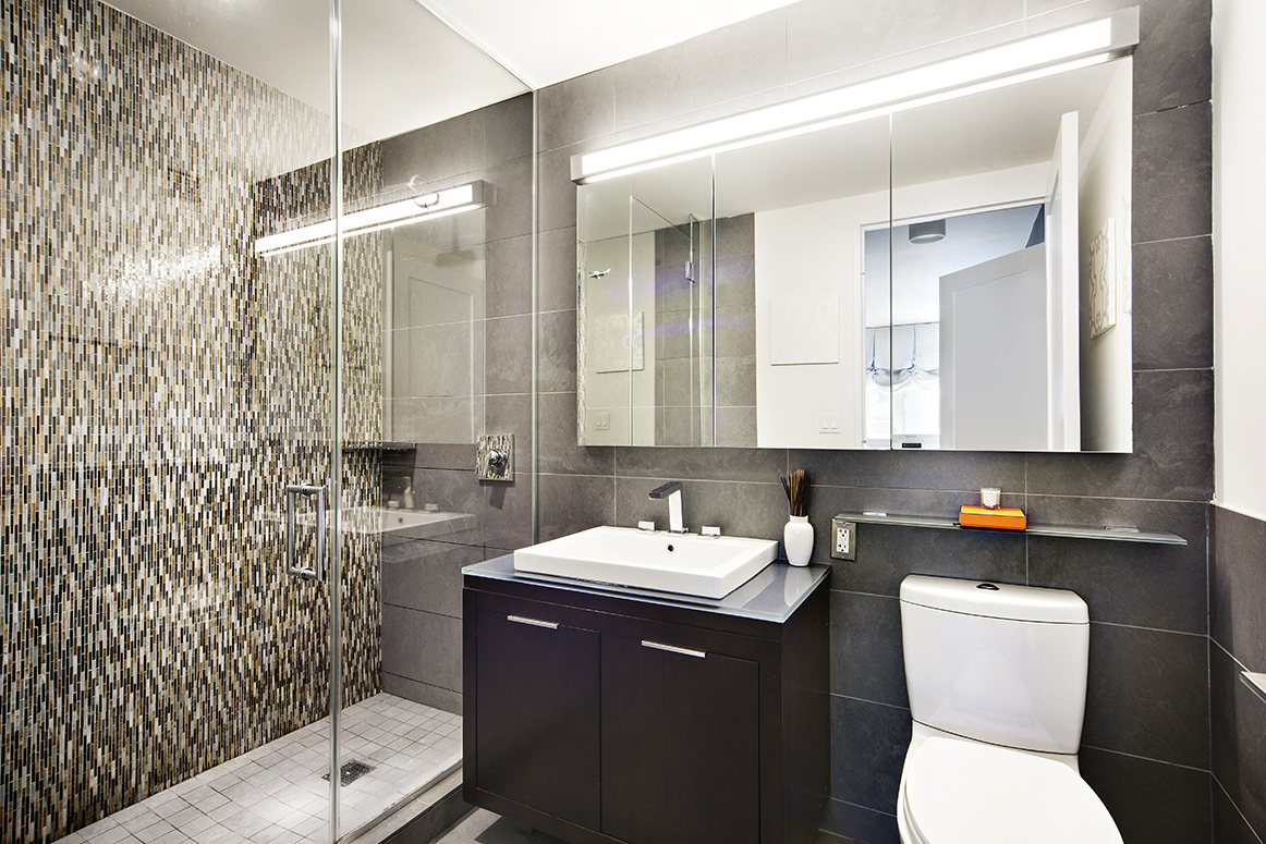 22 North 6th Street, Unit 18J Brooklyn, NY 11249 - Photo 6 of 18 a bathroom with a sink toilet vanity and shower