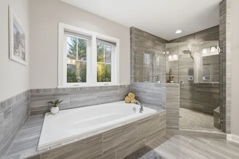 a spacious bedroom with a bed and a large window