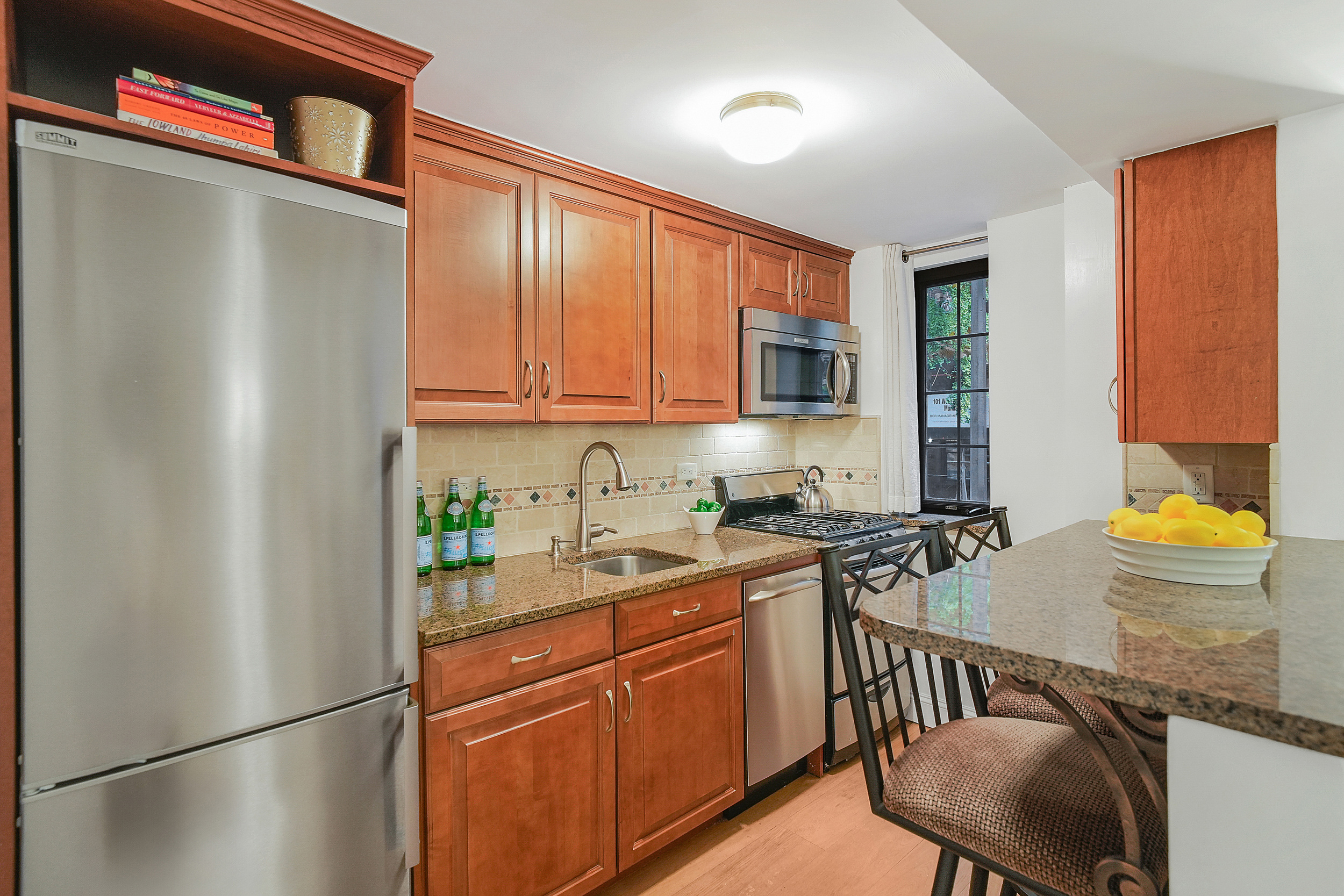 102 West 85th Street, Unit 2B Manhattan, NY 10024 - Photo 6 of 16 a kitchen with a refrigerator and a stove top oven