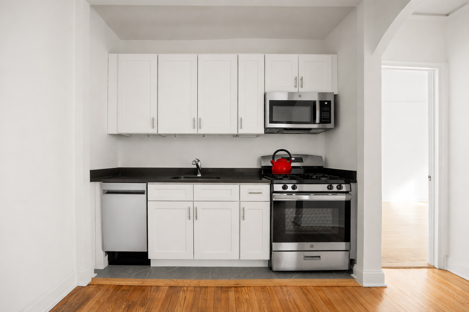 385 East 18th Street, Unit 4E Brooklyn, NY 11226 - Photo 3 of 7 a kitchen with stainless steel appliances granite countertop a stove and a microwave