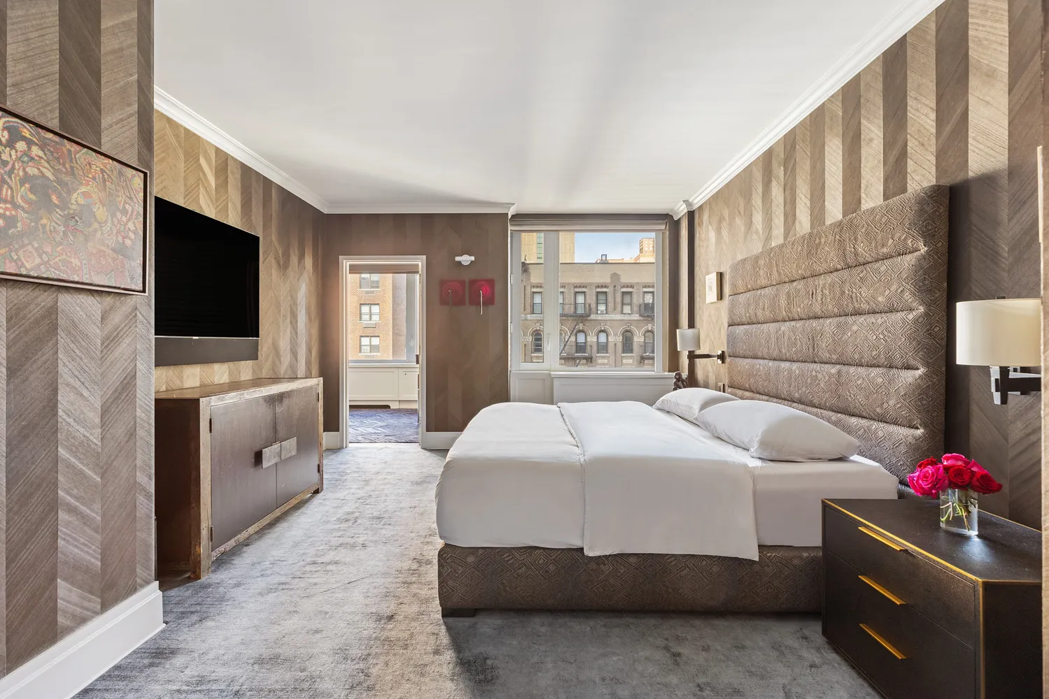 a bedroom with a bed and a flat screen tv