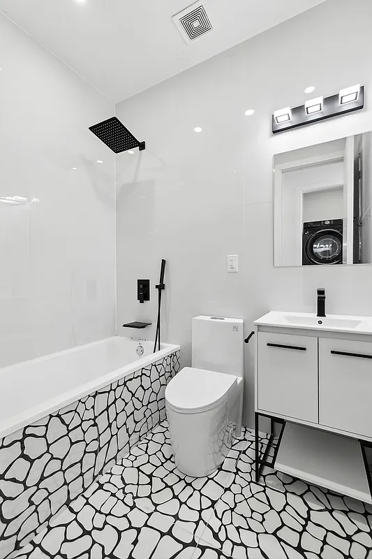 483 Hart Street, Unit PH Brooklyn, NY 11221 - Photo 14 of 17 a bathroom with a sink toilet and a mirror