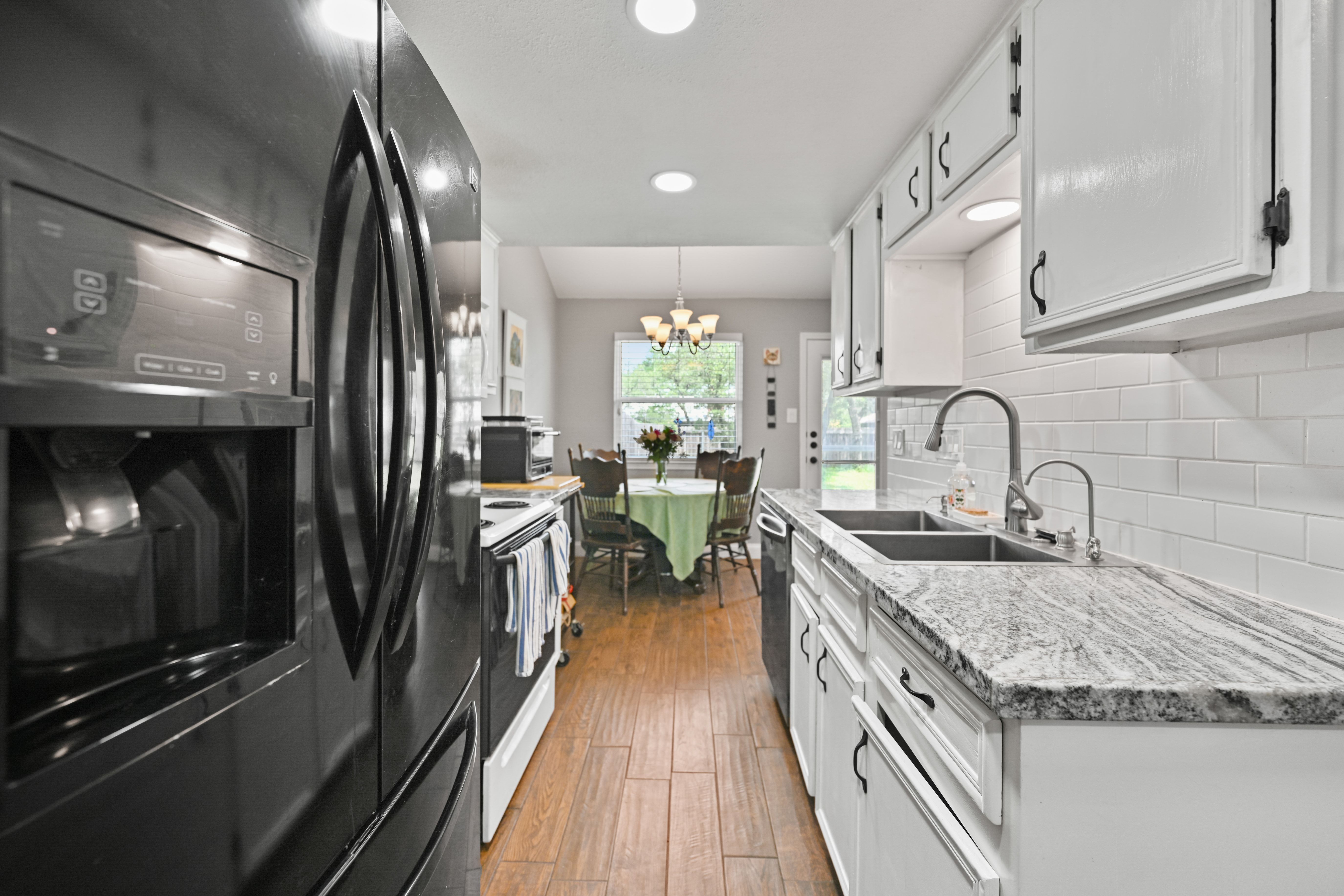 8710 Clearbrook Trail Austin, TX 78729 - Photo 4 of 28 a kitchen with sink stove refrigerator and cabinets