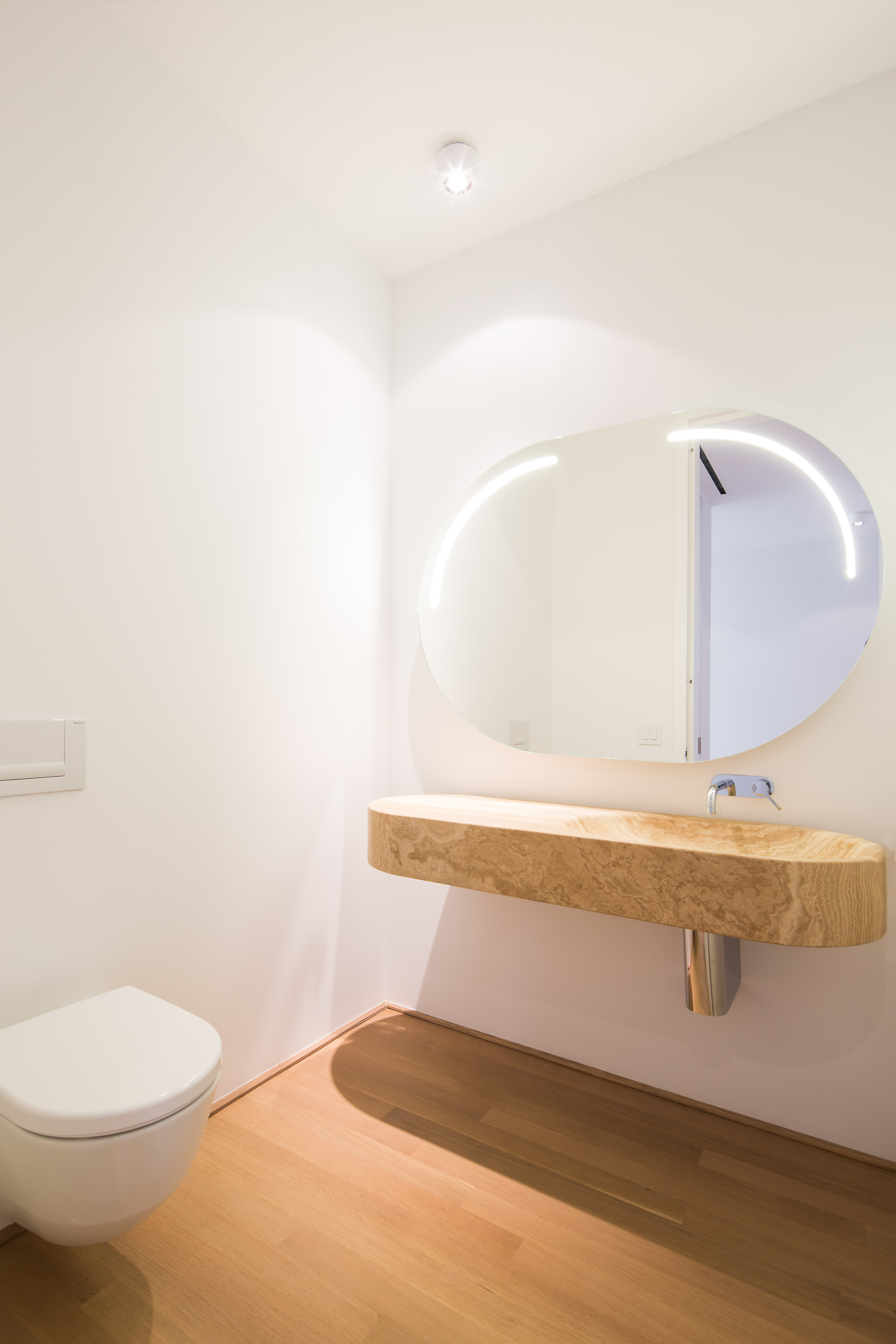 56 Leonard Street, Unit 12AEAST Manhattan, NY 10013 - Photo 5 of 11 a bathroom with a sink a toilet and mirror