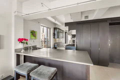 a kitchen with a table chairs and refrigerator