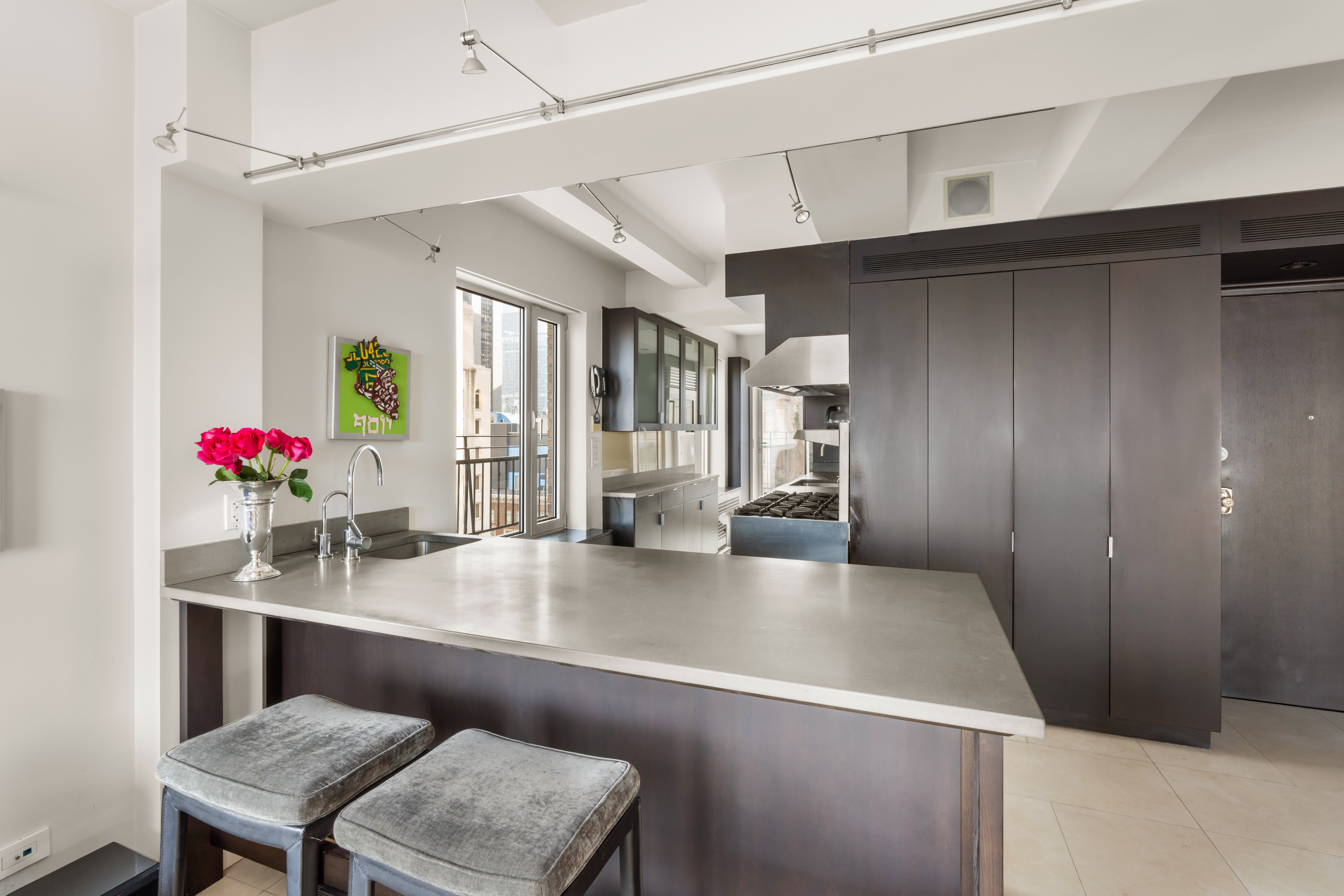 120 Central Park South, Unit PHE/W Manhattan, NY 10019 - Photo 4 of 11 a kitchen with a table chairs and refrigerator