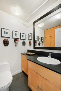 a bathroom with a granite countertop double vanity sink and a mirror