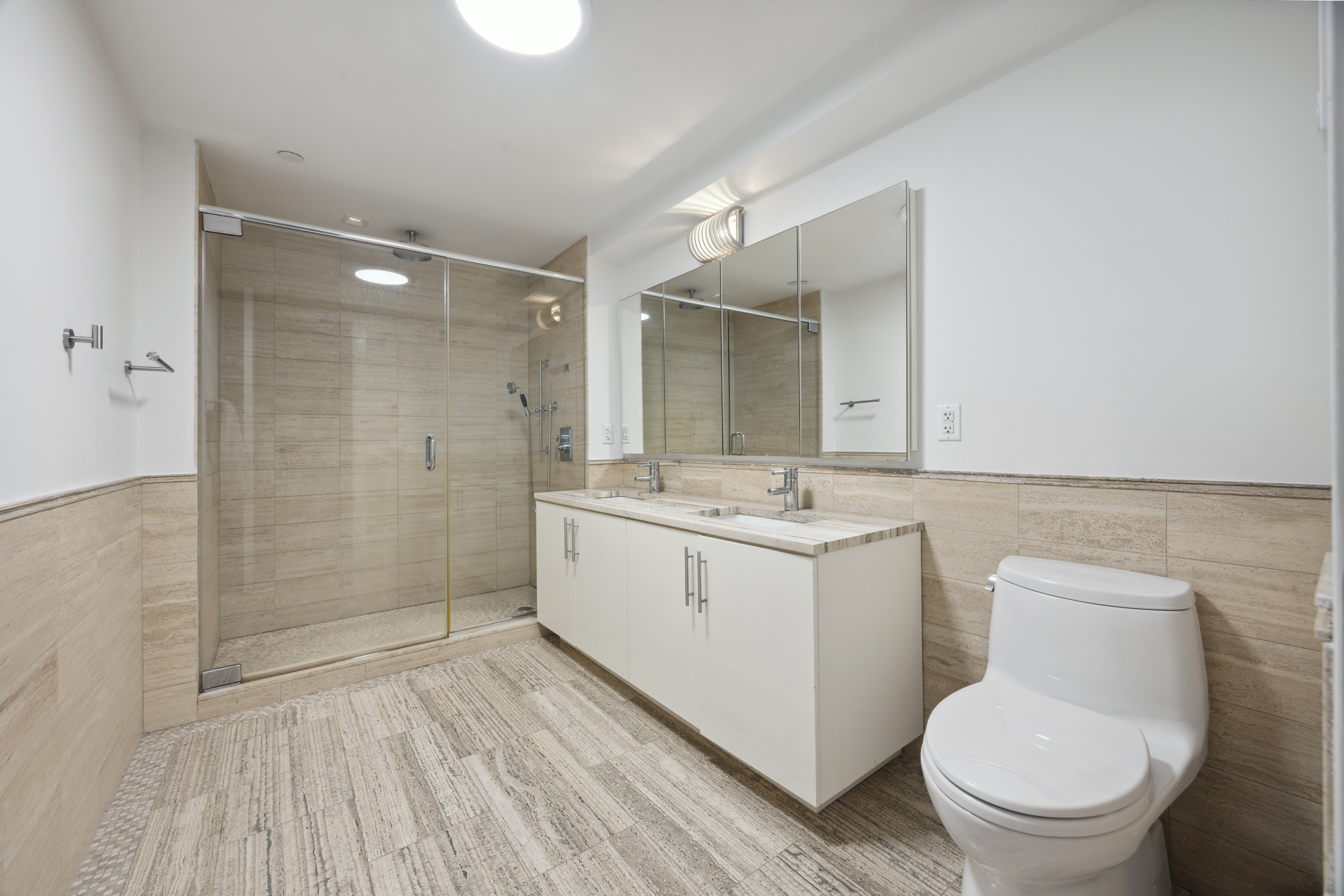 67 Liberty Street, Unit 10 Manhattan, NY 10005 - Photo 8 of 10 a bathroom with a sink a toilet and shower