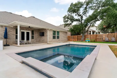 an aerial view of a house with a yard and seating space