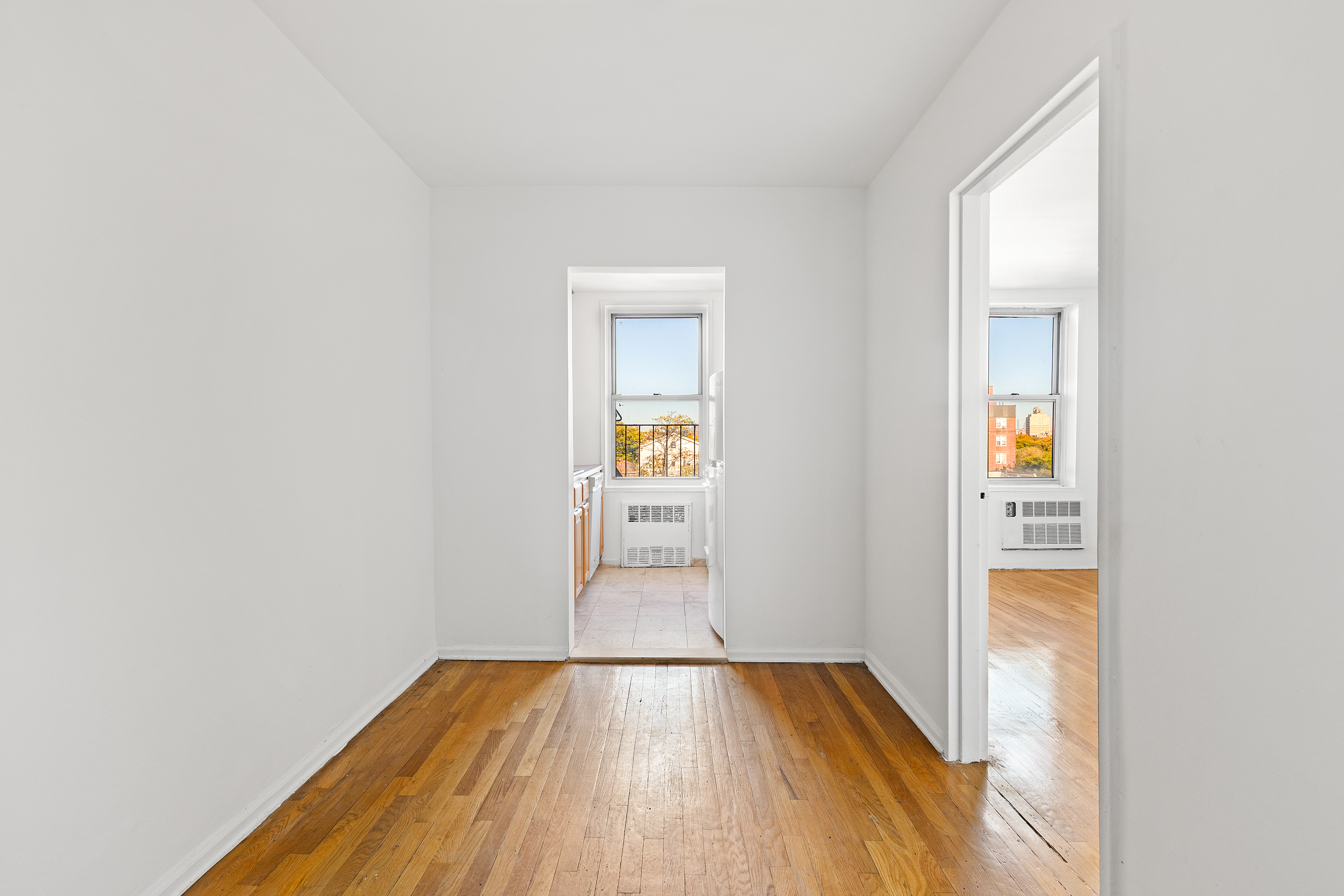 770 Ocean Parkway, Unit 6F Brooklyn, NY 11230 - Photo 12 of 17 an empty room with wooden floor and windows