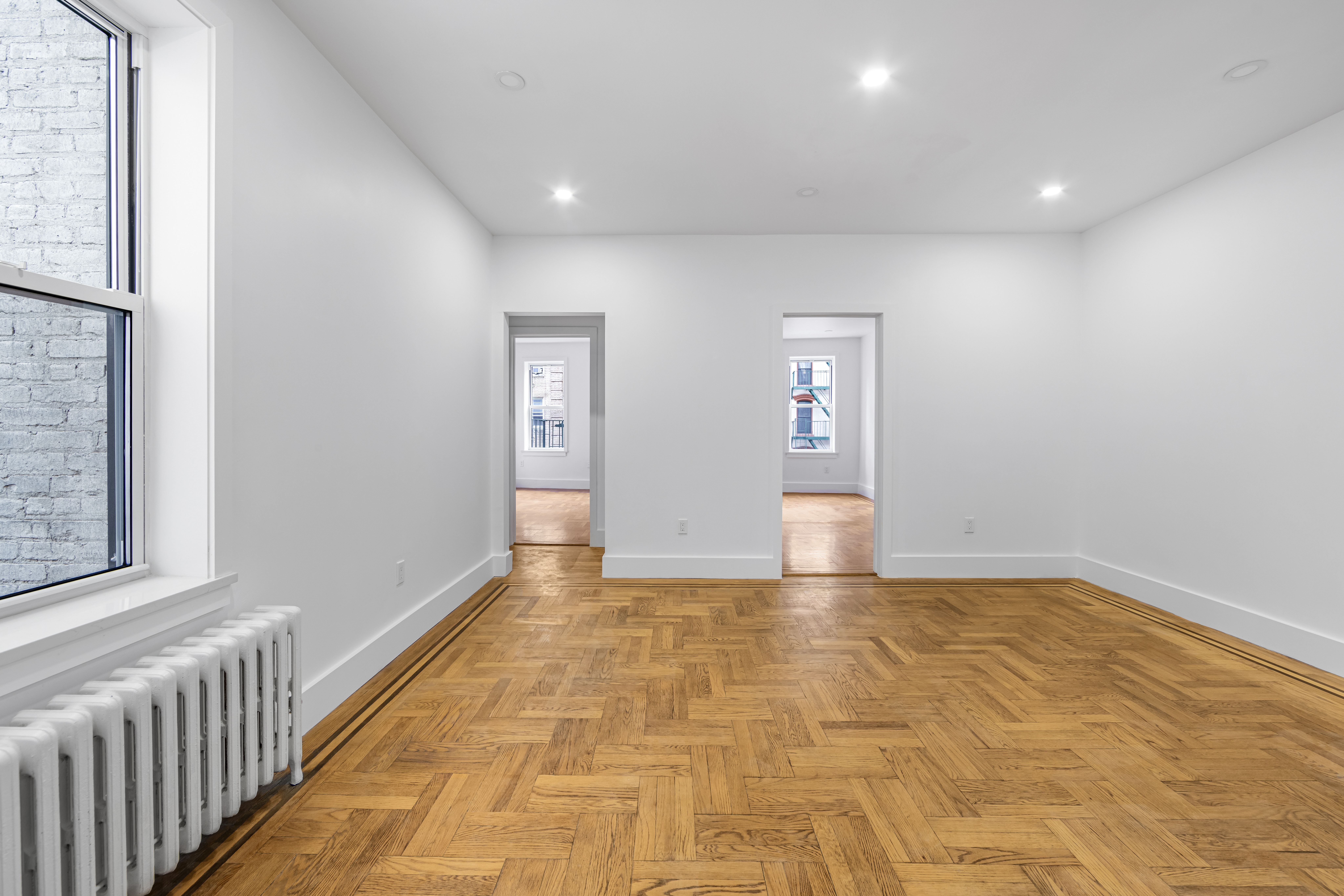 210 Grand Street, Unit 3F Manhattan, NY 10013 - Photo 2 of 11 a view of an empty room and window