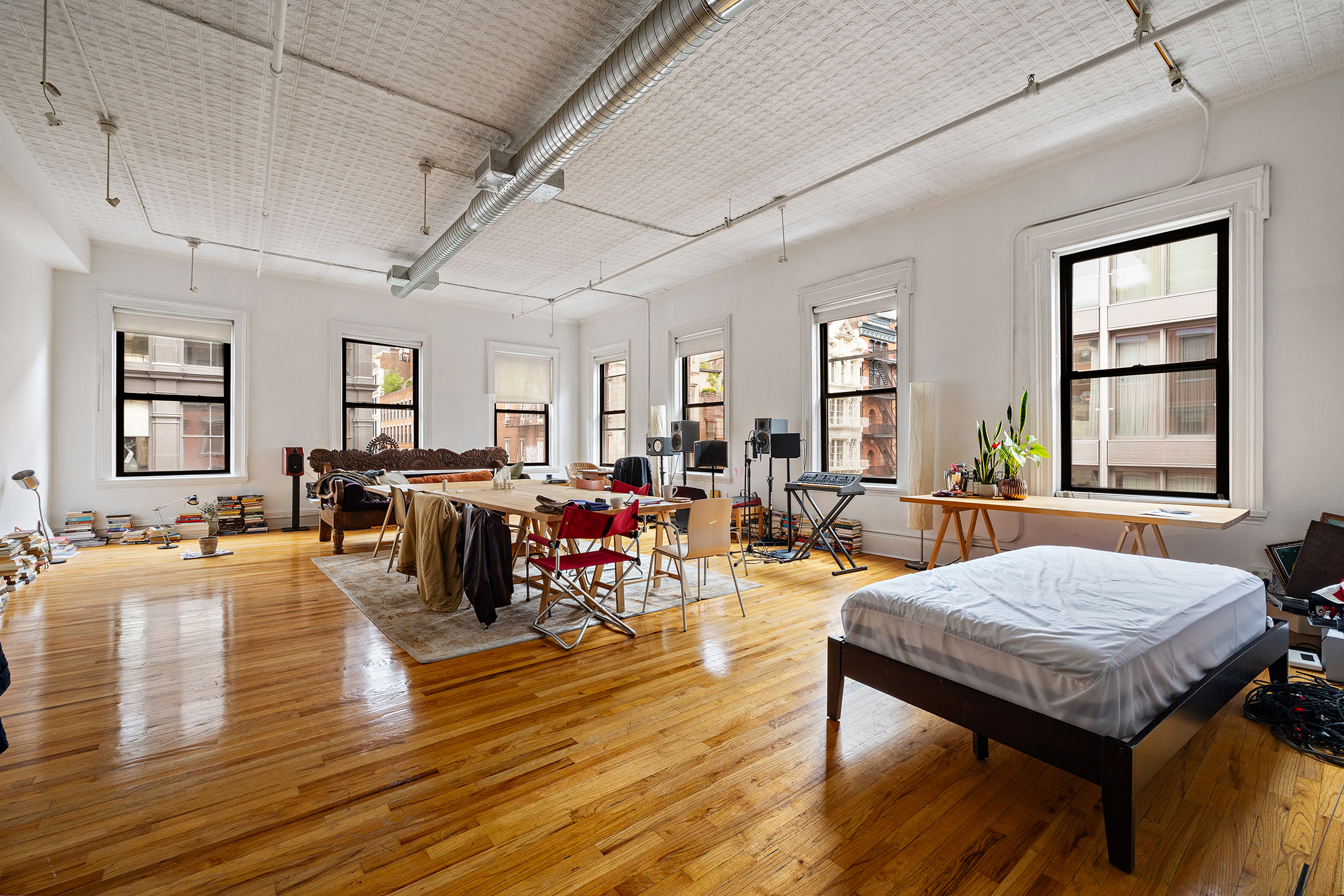 39 1/2 Crosby Street, Unit 4 Manhattan, NY 10012 - Photo 2 of 8 a living room with furniture and wooden floor