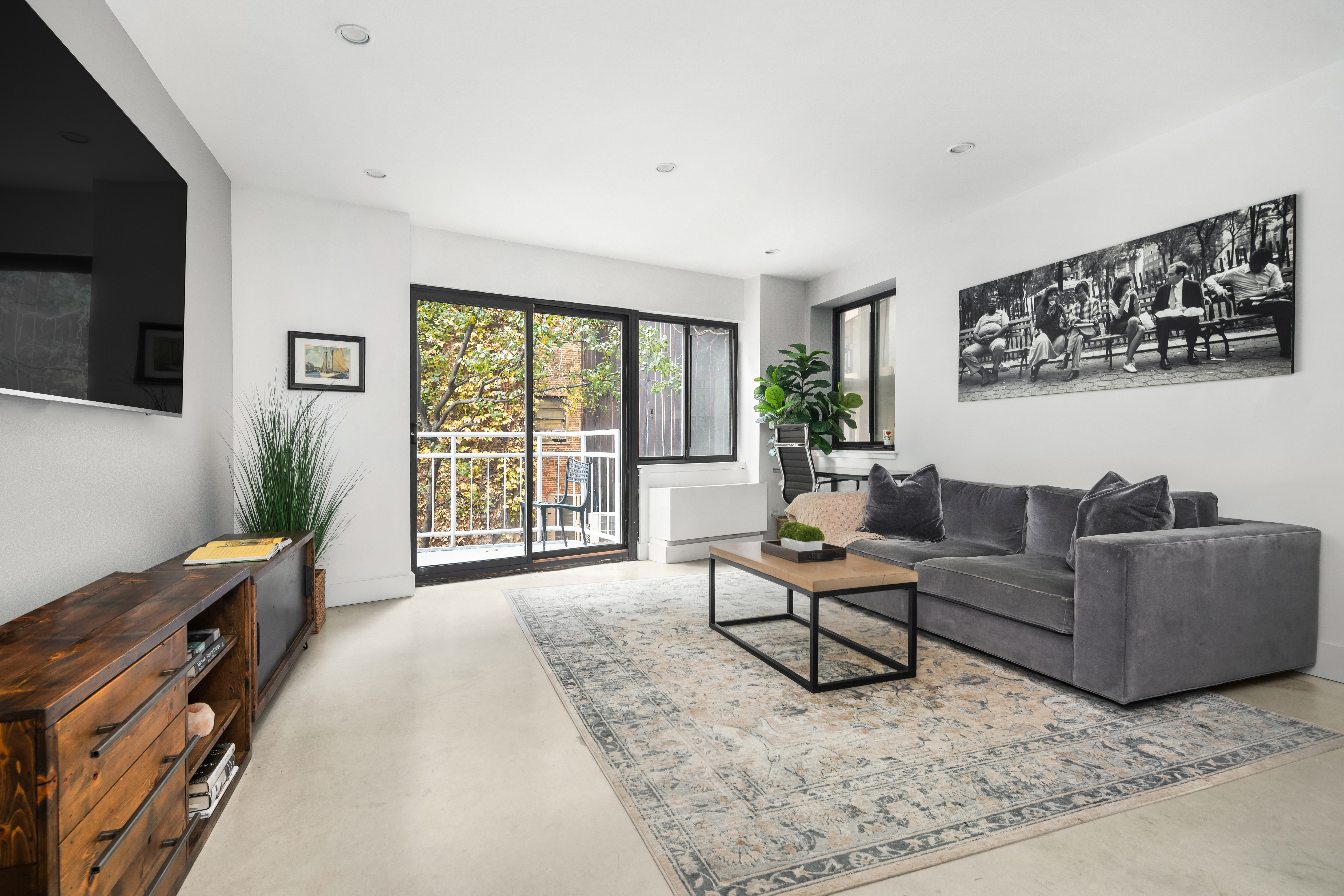 164 Bank Street, Unit 3A Manhattan, NY 10014 - Photo 3 of 8 a living room with furniture and a flat screen tv