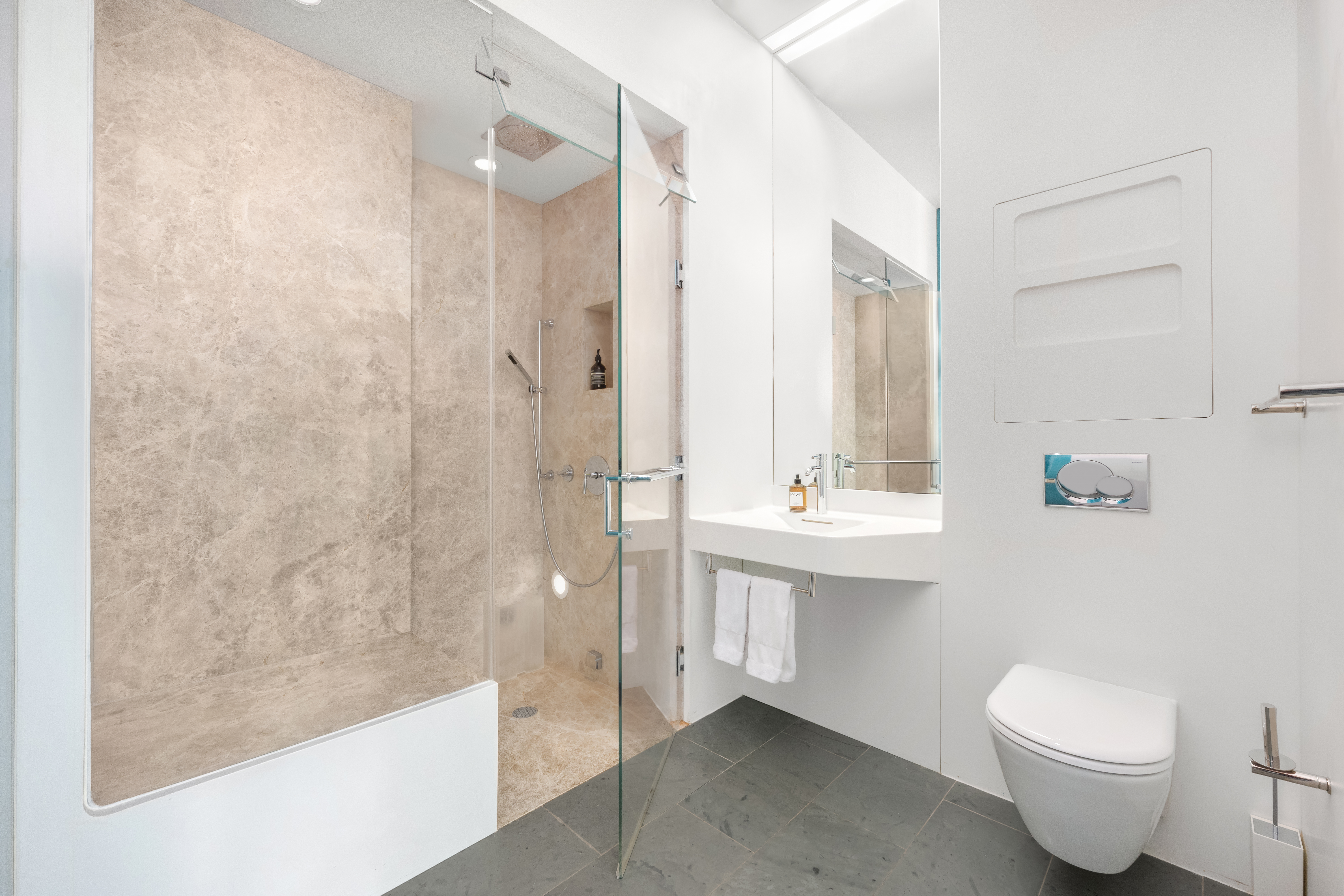 166 Perry Street, Unit 6A Manhattan, NY 10014 - Photo 14 of 20 a bathroom with a sink a toilet and shower