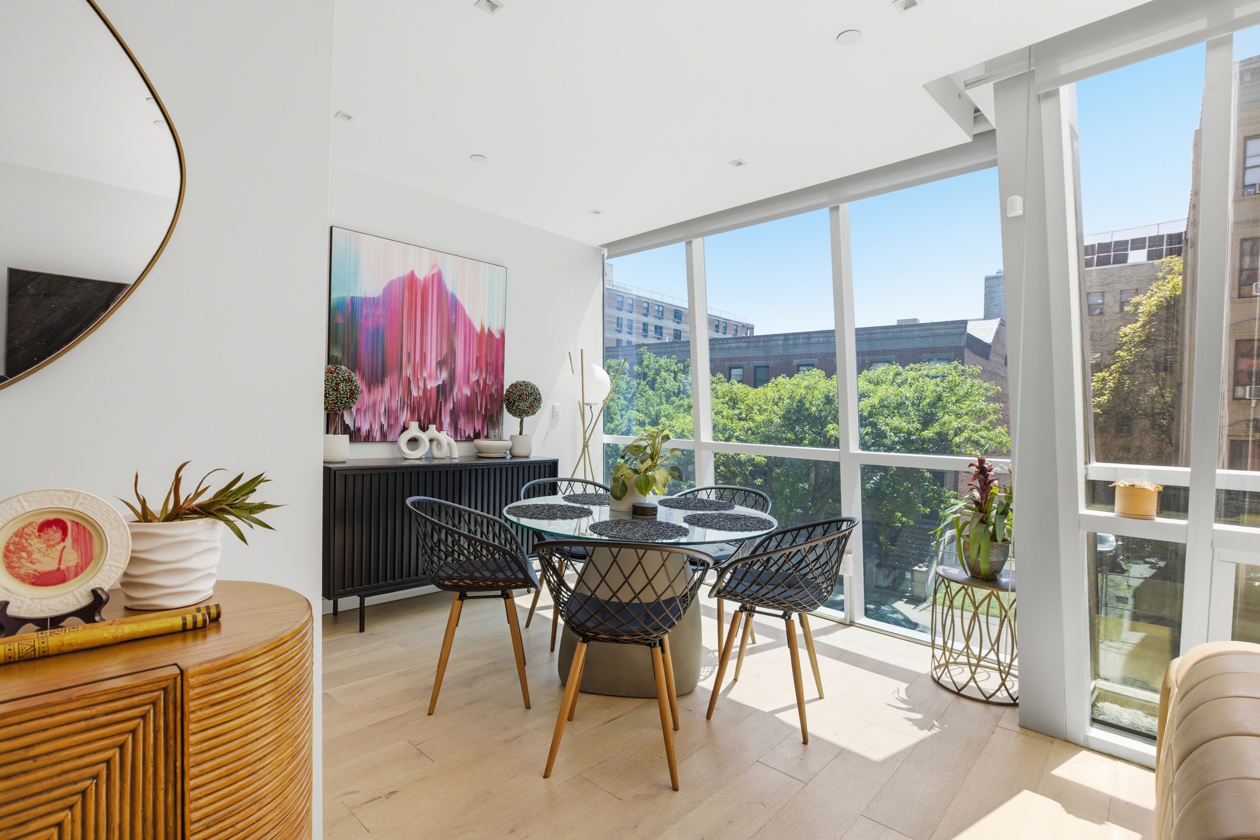 313 West 121st Street, Unit 2 Manhattan, NY 10027 - Photo 3 of 12 a view of a dining room with furniture one side kitchen view and wooden floor