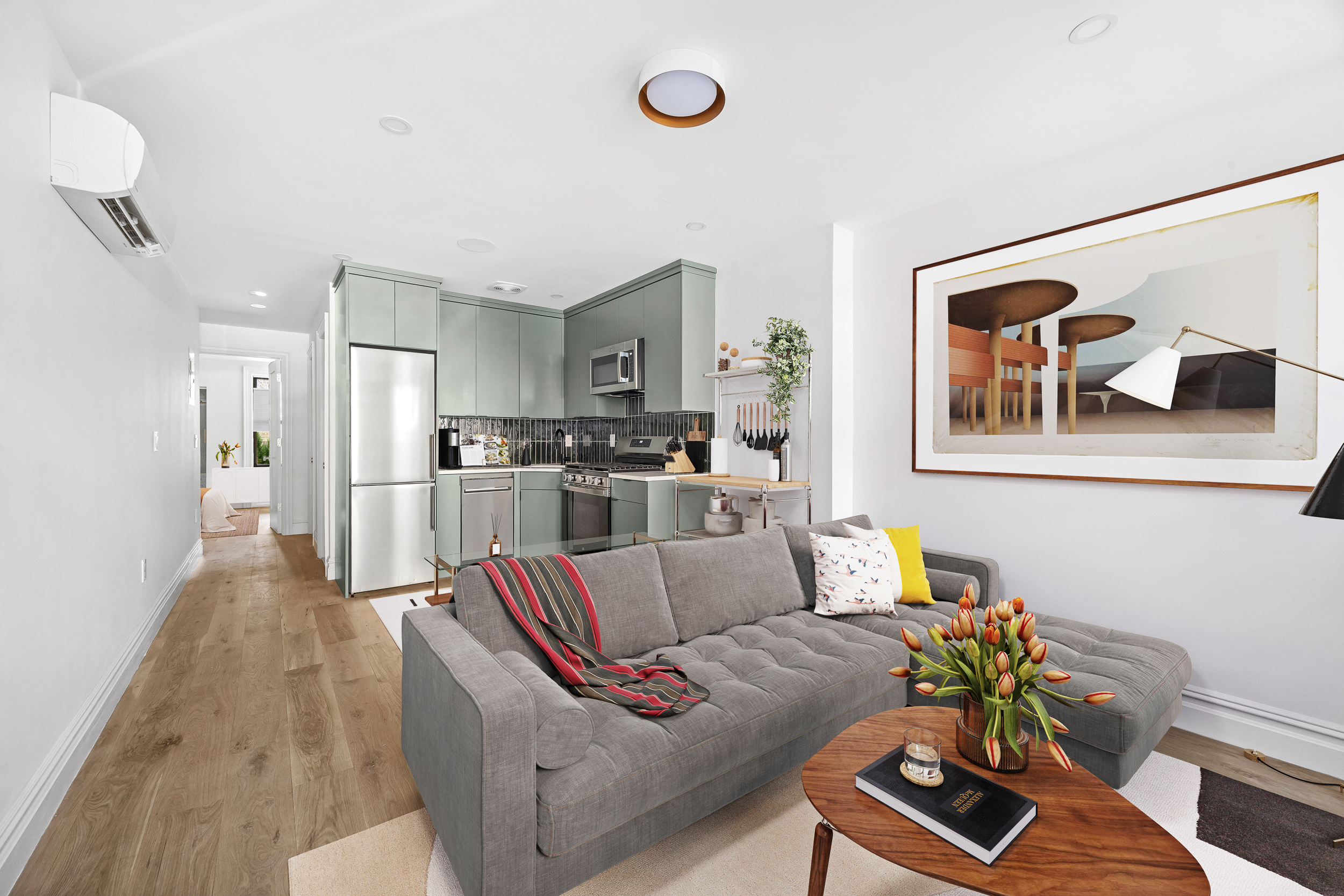 a living room with furniture and wooden floor