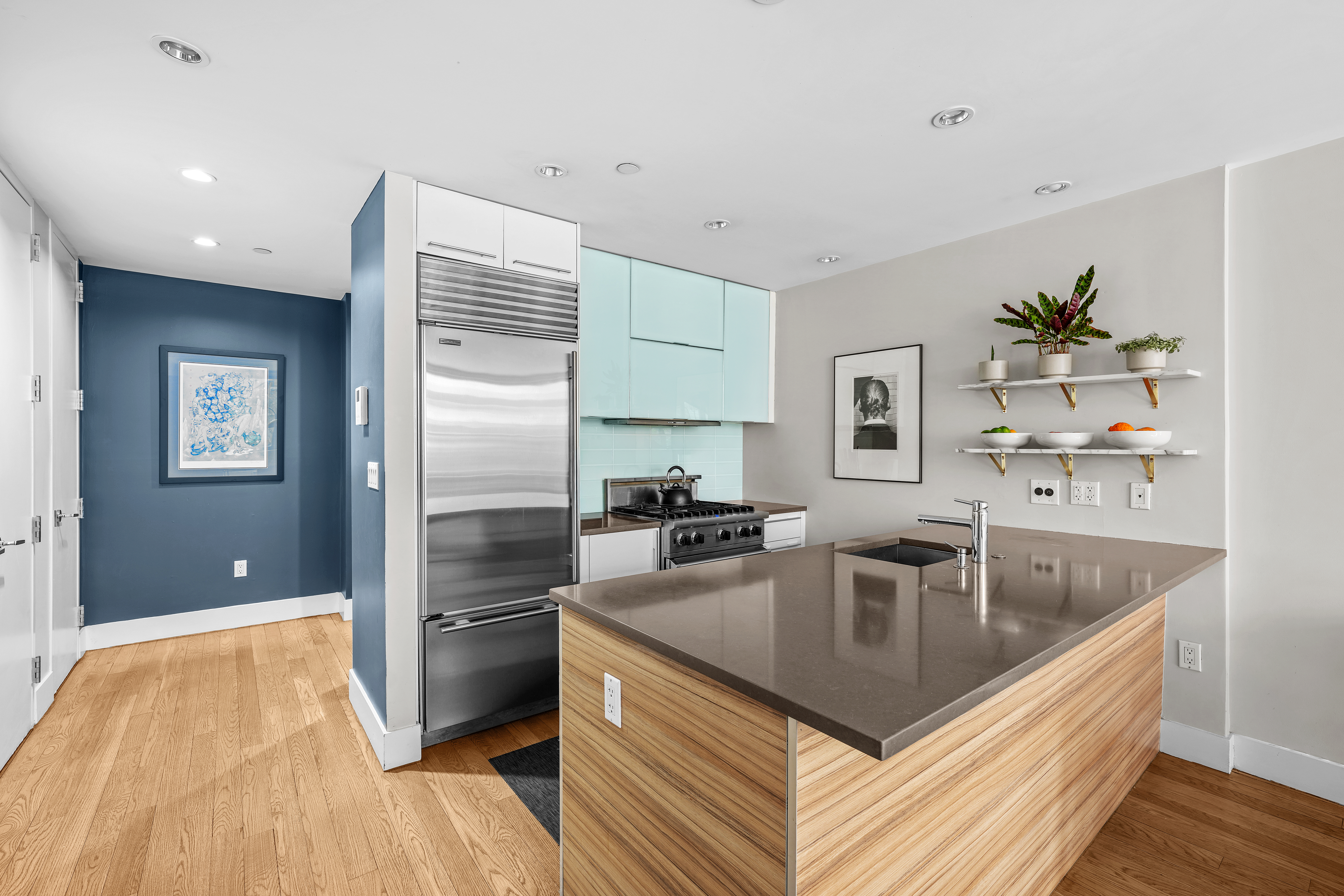 117 West 123rd Street, Unit 1B Manhattan, NY 10027 - Photo 7 of 25 a kitchen with stainless steel appliances granite countertop a sink a stove and a refrigerator