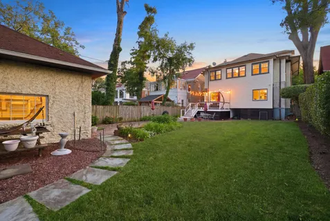 a view of an house with backyard space and sitting area