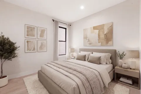 a bedroom with a large bed and a window