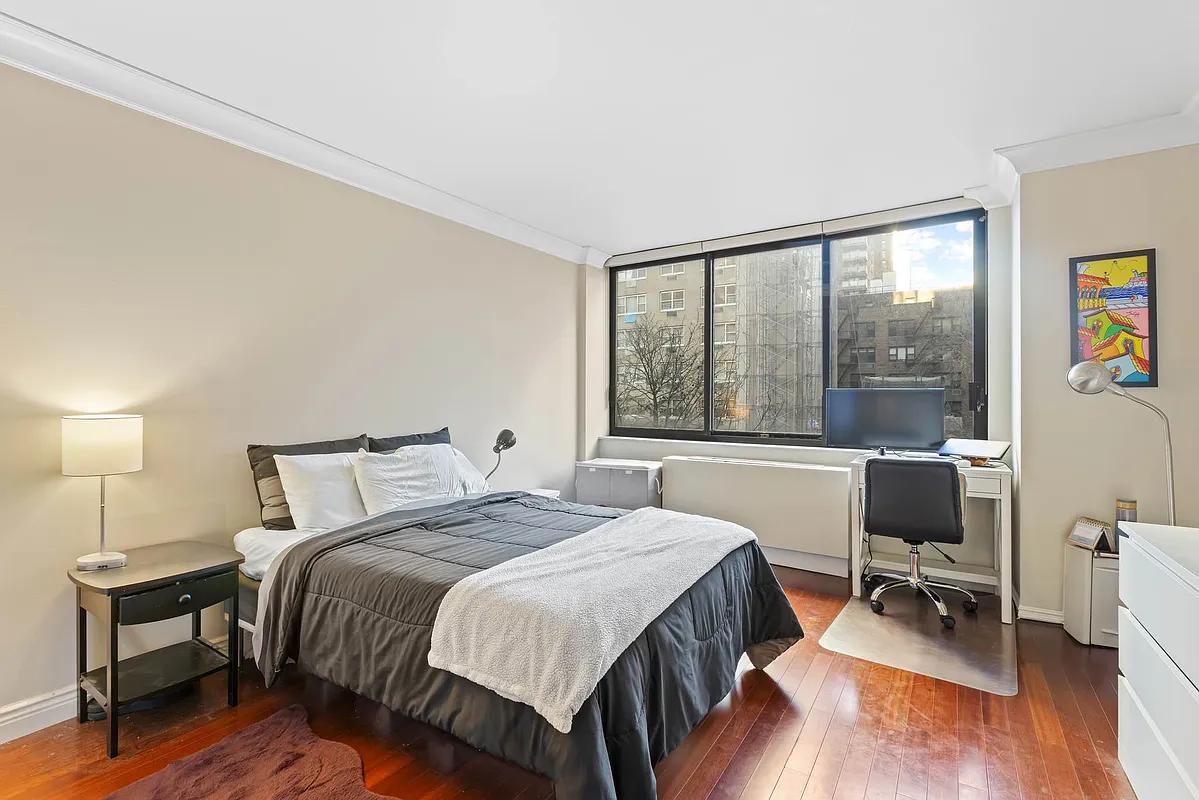 510 East 80th Street, Unit 4D Manhattan, NY 10075 - Photo 8 of 20 a bedroom with a bed and a large window