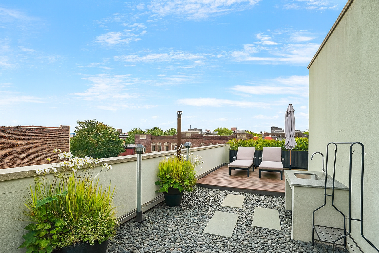 449 Decatur Street, Unit 3A Brooklyn, NY 11233 - Photo 8 of 9 a view of a lake with couches chairs and city view