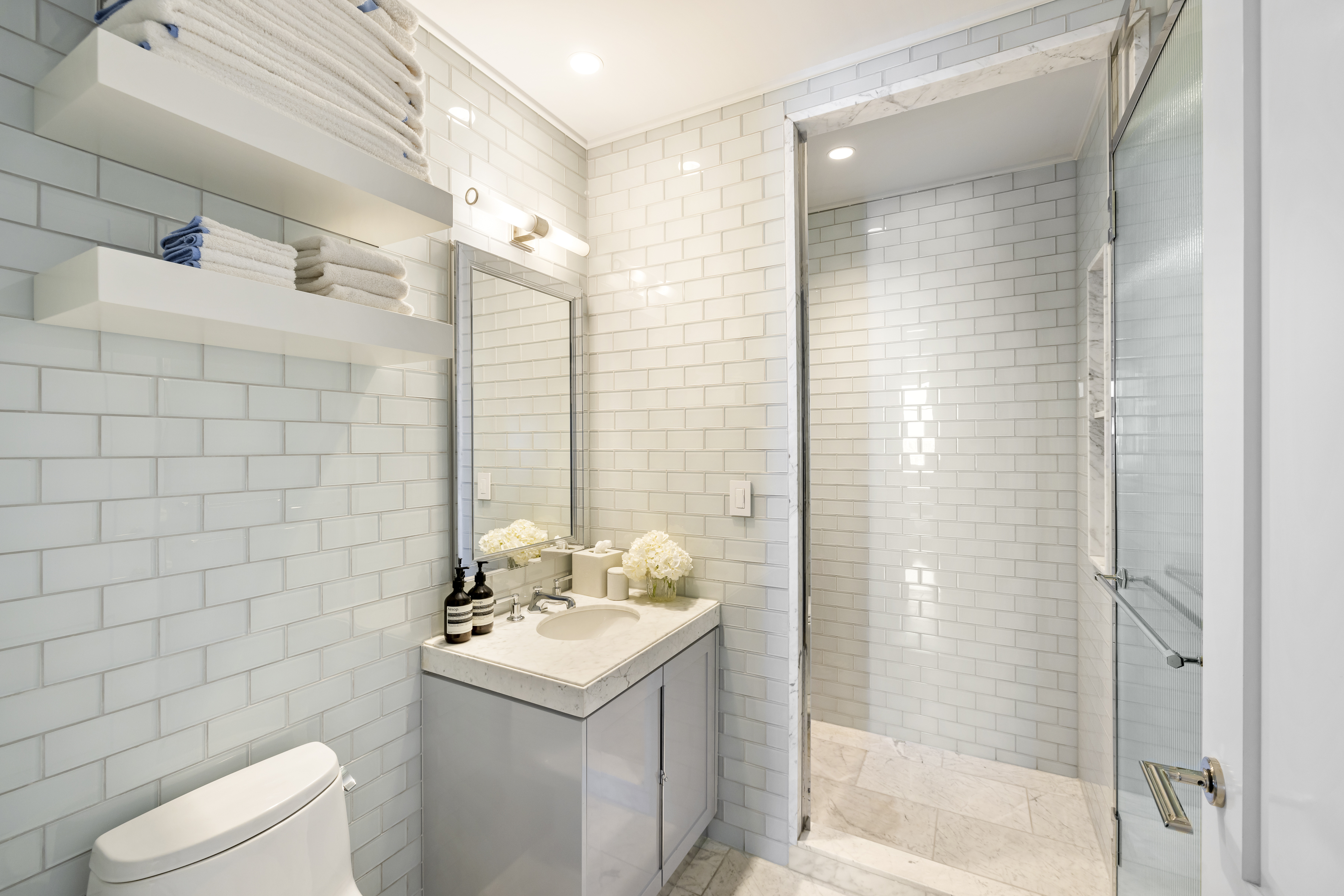 301 East 80th Street, Unit 25B Manhattan, NY 10075 - Photo 22 of 38 a bathroom with a sink a toilet and shower