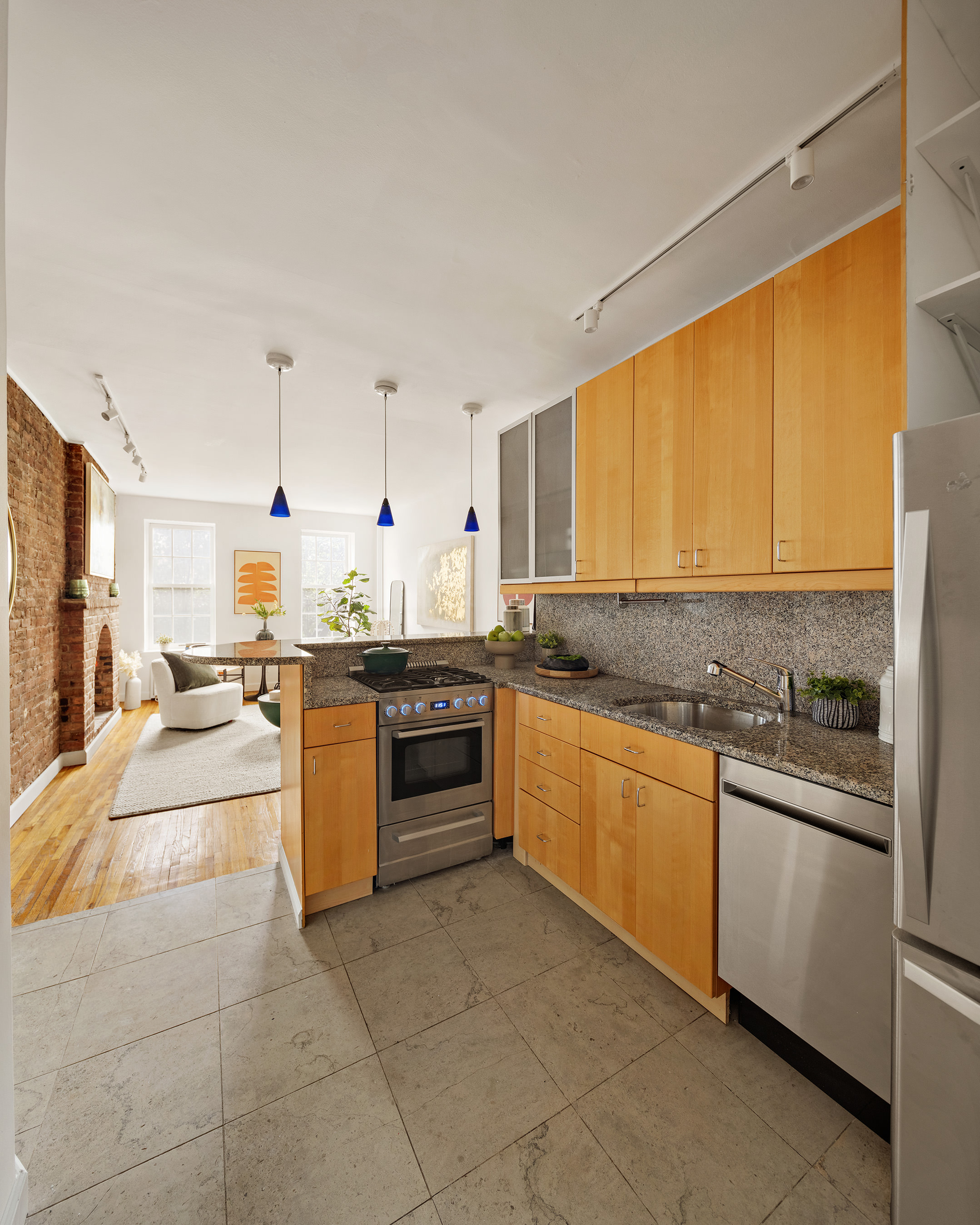 333 West 21st Street, Unit 2FE Manhattan, NY 10011 - Photo 3 of 10 a large kitchen with cabinets and stainless steel appliances
