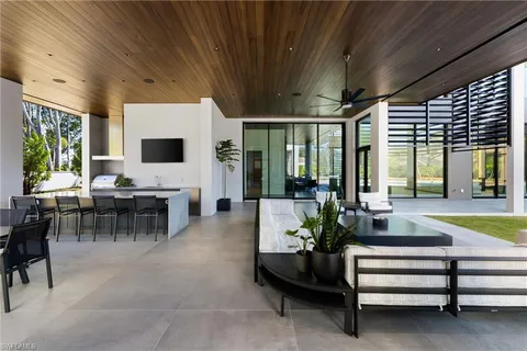 a lobby with furniture and large windows