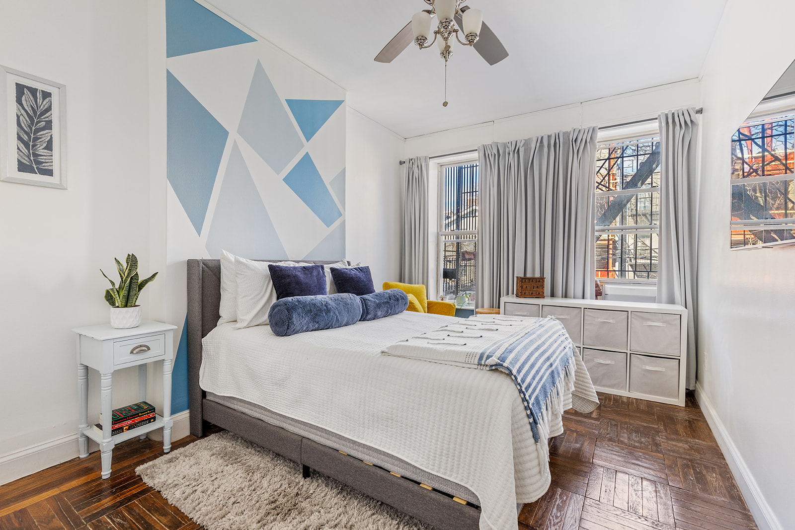 231 Vernon Avenue Brooklyn, NY 11206 - Photo 3 of 13 a bedroom with a bed and a chandelier