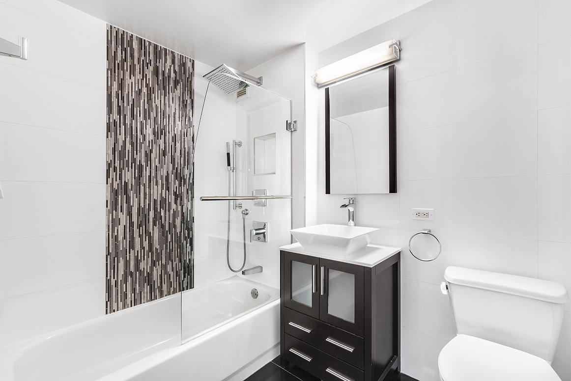 520 West 23rd Street, Unit 9D Manhattan, NY 10011 - Photo 7 of 10 a bathroom with a sink toilet and shower